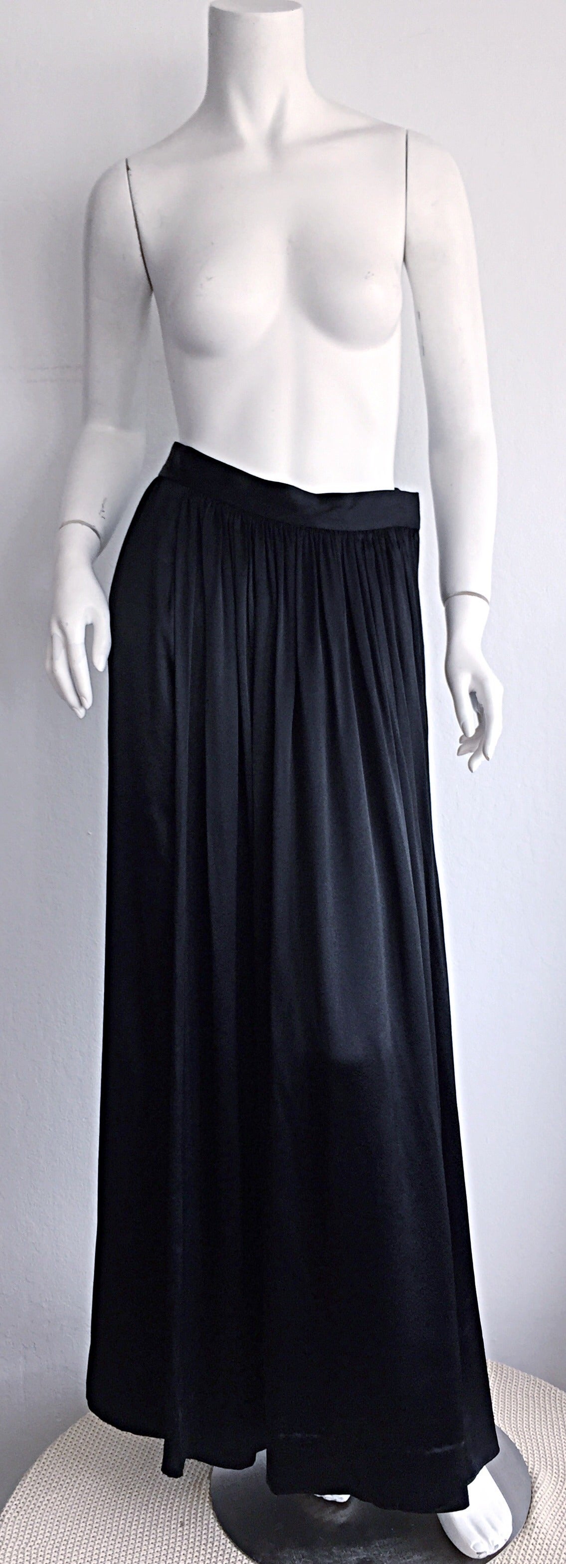 Quite possibly the most amazing vintage late 1970s Yves Saint Laurent YSL skirt that I have ever seen! This chic YSL maxi skirt feels, and looks like liquid silk! Unbelievable movement when worn! Pleats in front, in a mock-wrap style. Extremely
