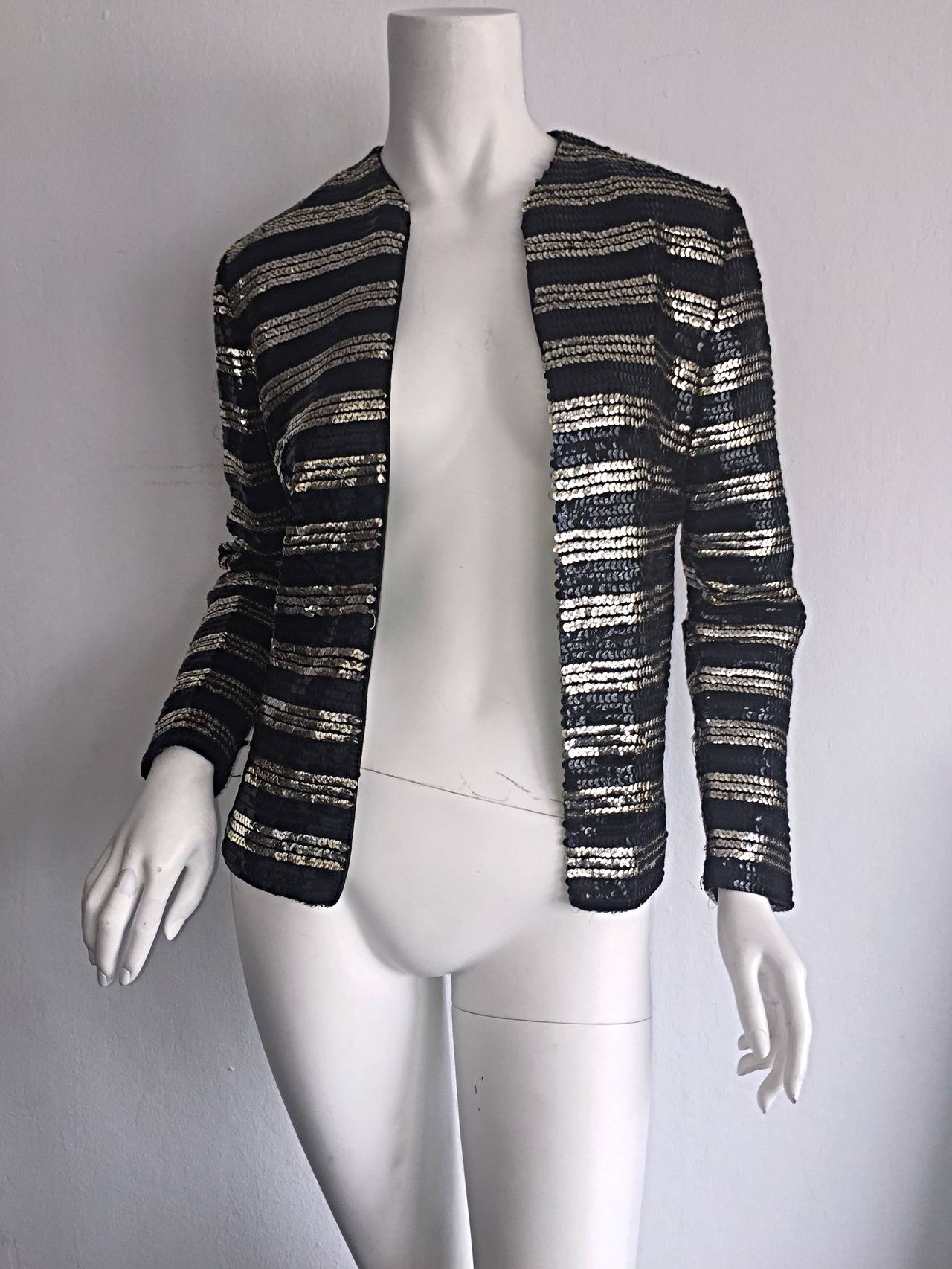 Beautiful 1950s black and white gold sequin cardigan by French design House, Malbe Original! Open faced cardigan has an appealing fit, with all over sequins. The perfect layering piece! Goes great with jeans, yet stunning over a cocktail dress.