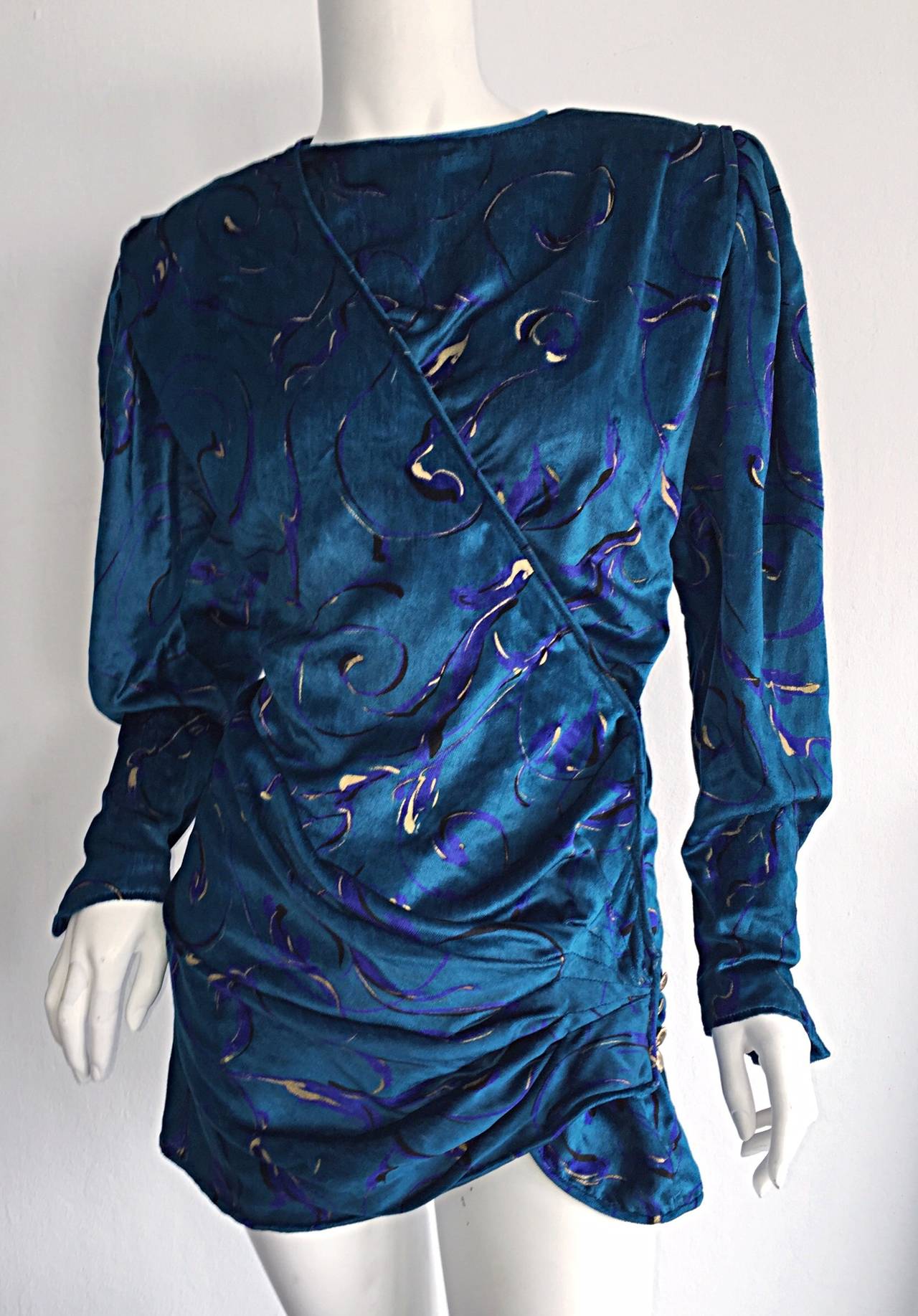 From the king of chic blouses, comes this beautiful vintage Emanuel Ungaro hand painted silk velvet blouse! Beautiful detail, which includes ruching at side waist, with gold buttons, inside wrap ties to adjust size, and gold buttons at cuff. Neck