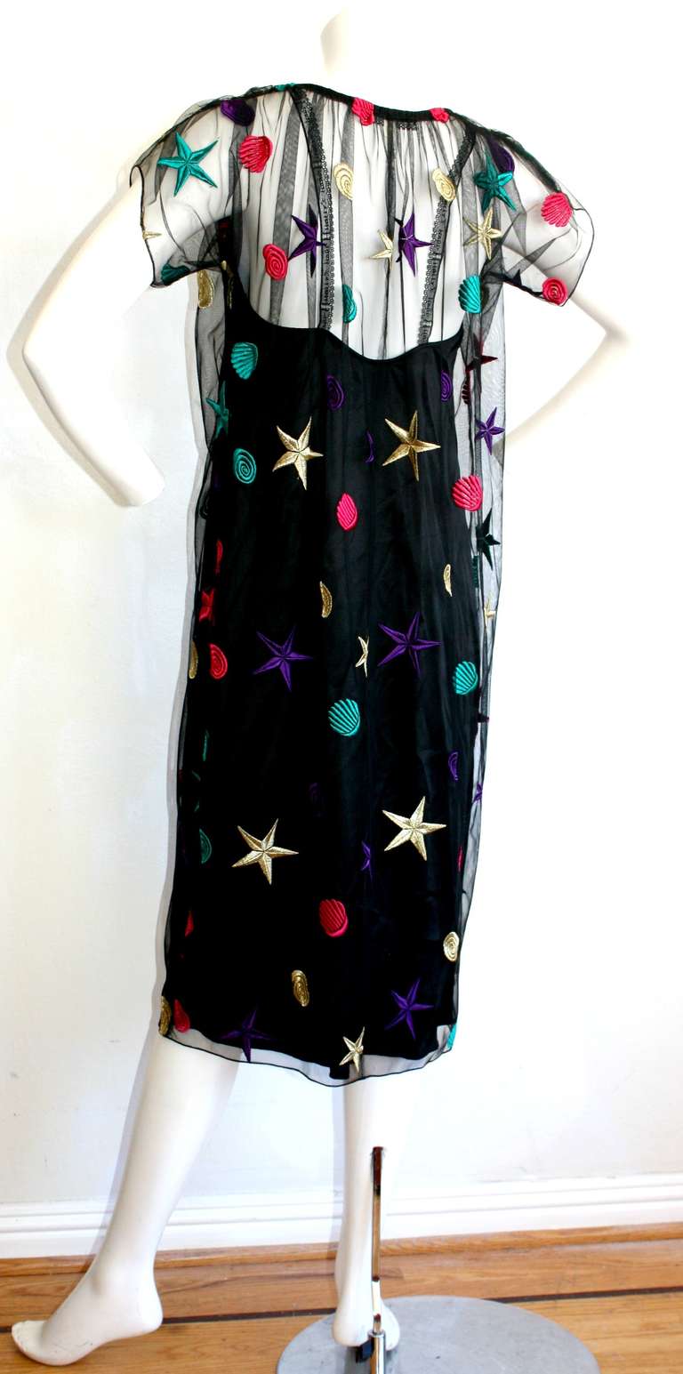 Beautiful two-piece vintage Holly Harp black dress. Slip underlay may be worn as chic black dress (features Holly's Harp signature on lace straps). Net overlay features colorful stars and seashells. Looks great belted! Perfect party Las Vegas dress!