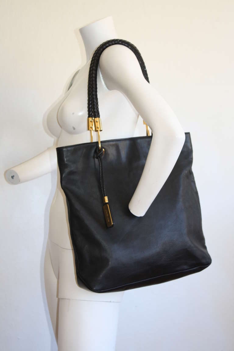 Brand new Michael Kors Collection black leather Skorpios Shopper tote. Features gorgeous classic braided handles that fit comfortably on the shoulder. Gold hardware that has 18k gold plating that adds luster. Easily fits s laptop Beige silk lining,
