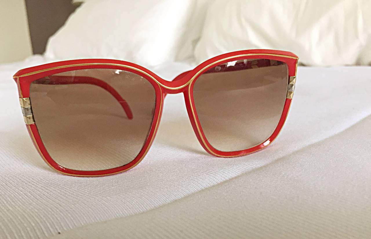 Super rare 1970s Leonard red sunglasses! Made in France. These beauties feature a cat-eye shape that flatters any shape! Never worn. In great condition. Made in France. Bright red, with silver and gold accents.