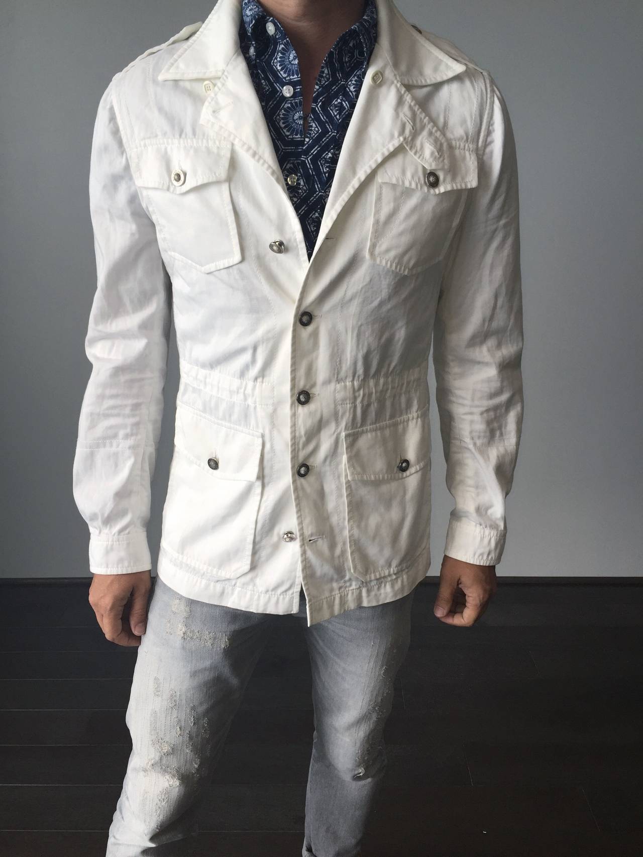 Awesome Balenciaga by Nicolas Ghesquiere men's white safari jacket! Features silver signature buttons up front,with marching buttons at pockets, and at cuffs. Interior draawstring at waist to ensure a great slim fit! Lightweight cotton. In great