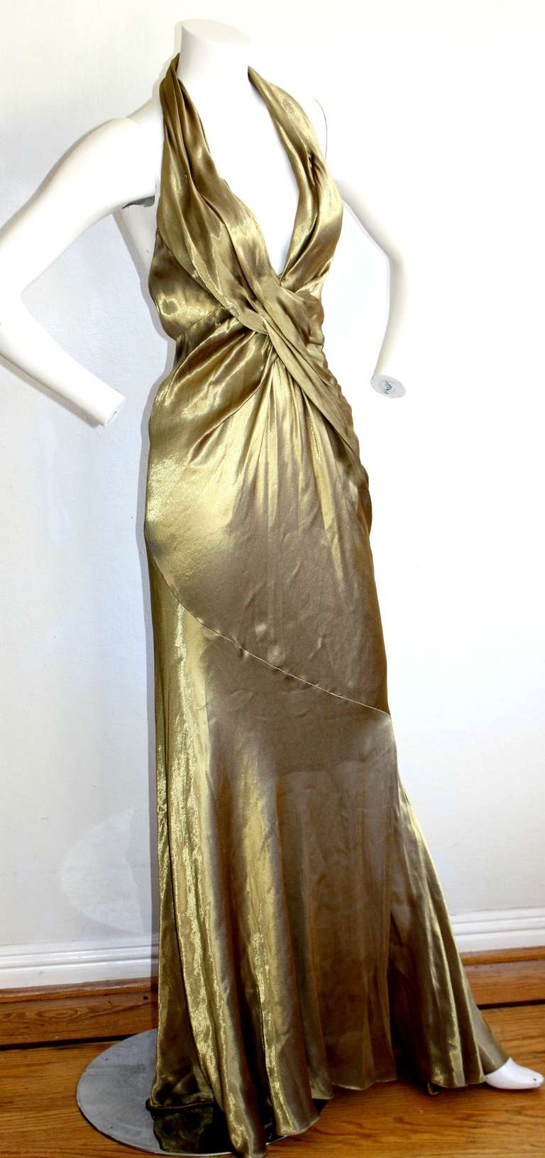 Gorgeous vintage 1990s Donna Karan liquid gold gown. Slinky halter style, with sexy open back. Ruching detail that makes for a flattering bodycon fit. Marked Size Us 2, but will fit 4 as well due to stretch.