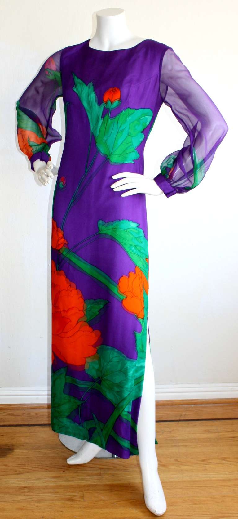 Beautiful Hanae Mori vintage couture numbered gown. Vibrant purple, with layers of chiffon of same print that makes for a 3-D effect. Long billowing sheer sleeves, with adjustable snap closures. Sexy side slit. Can be worn by a variety of sizes,
