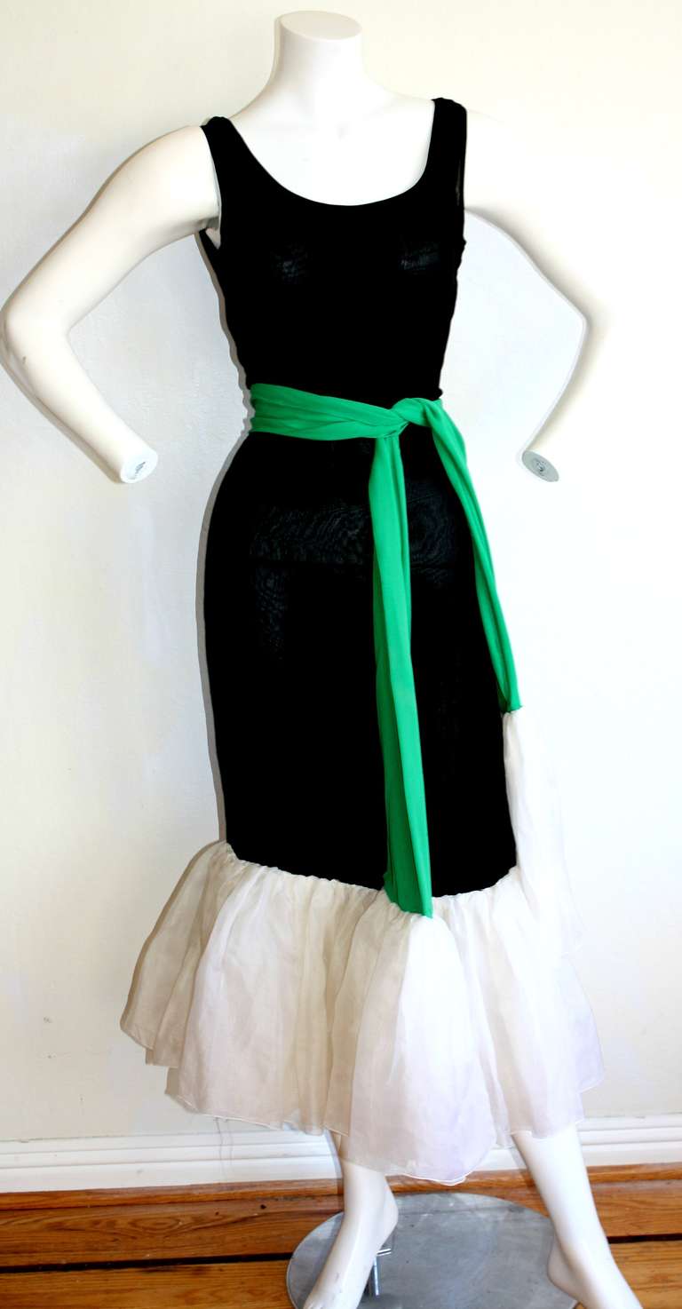 Gorgeous vintage black Pierre Cardin dress with flared white chiffon hem, and matching vibrant kelly green signature clover belt/sash. Flattering hugging fit. Features hidden side zip. Double layer silk jersey. In great condition. Approximately Size