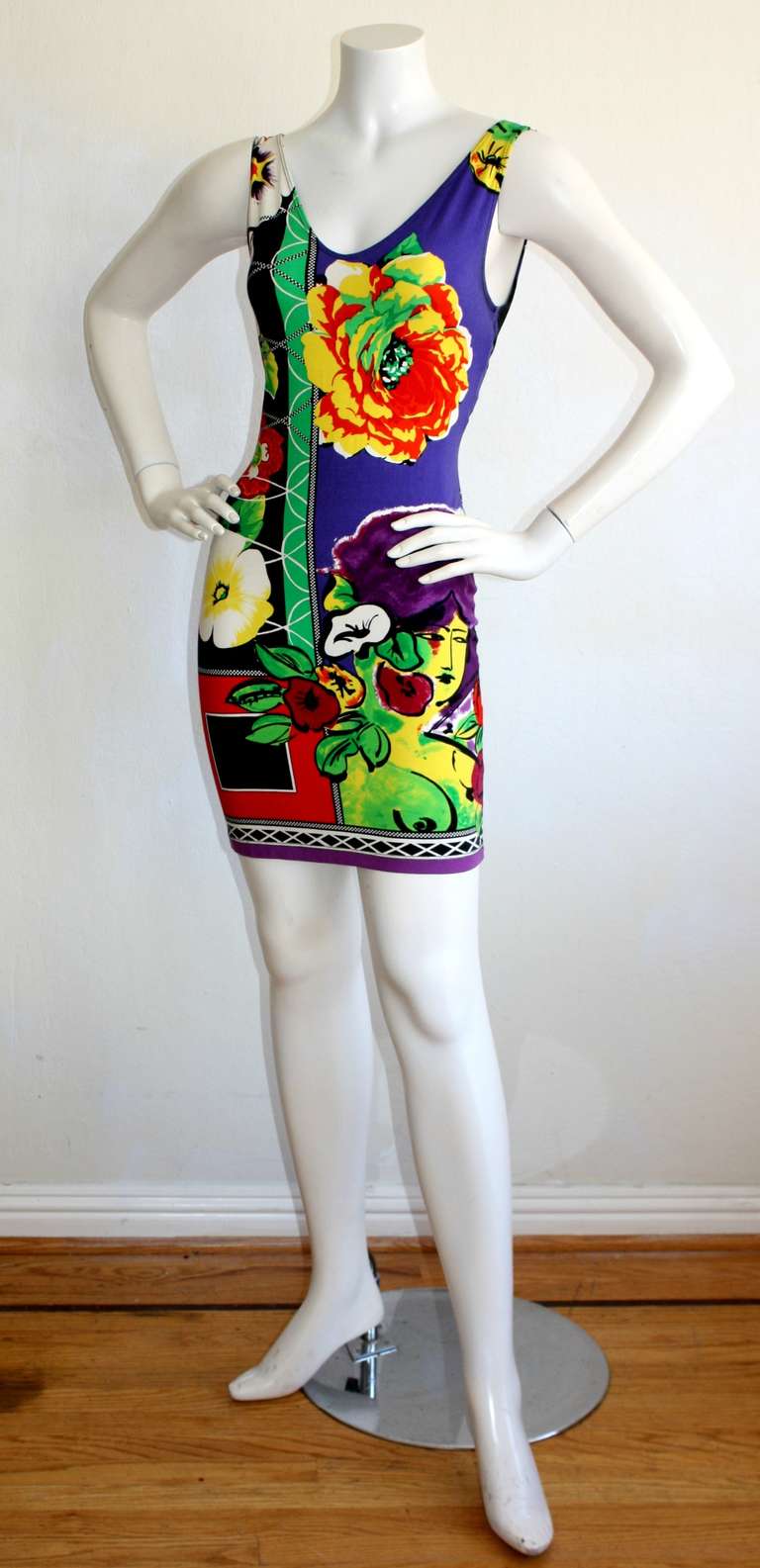 Sexy vintage Gianni Versace stretch mini dress for the 1990s prior to his tragic death. Features signature Versace prints throughout. Gorgeous vibrant colors, with a flattering, and, oh so sexy fit. Beautiful open back. Approximately Size Small -