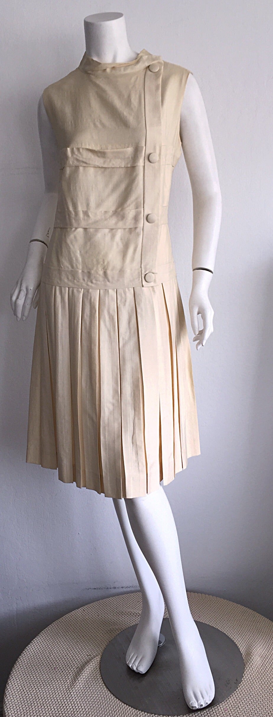 Extremely rare 1960s Elsa Schiaparelli ivory silk dress! Schiaparelli dresses are very hard to find, but when you do find one, the response is breathtaking!!! Ivory silk, with four buttons down the side bodice, and a fully pleated skirt, with a