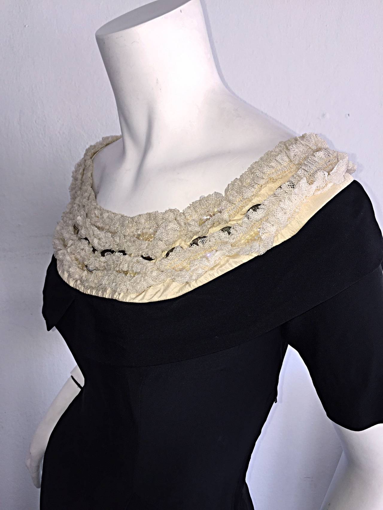 Beautiful late 1950s Pattullo-Jo Copeland little black dress! Impeccable construction, with and ultra flattering fit! Cute black collar, below ruffles of ivory silk lace, intertwined with oval rhinestones. There is an insane amount of detail to this