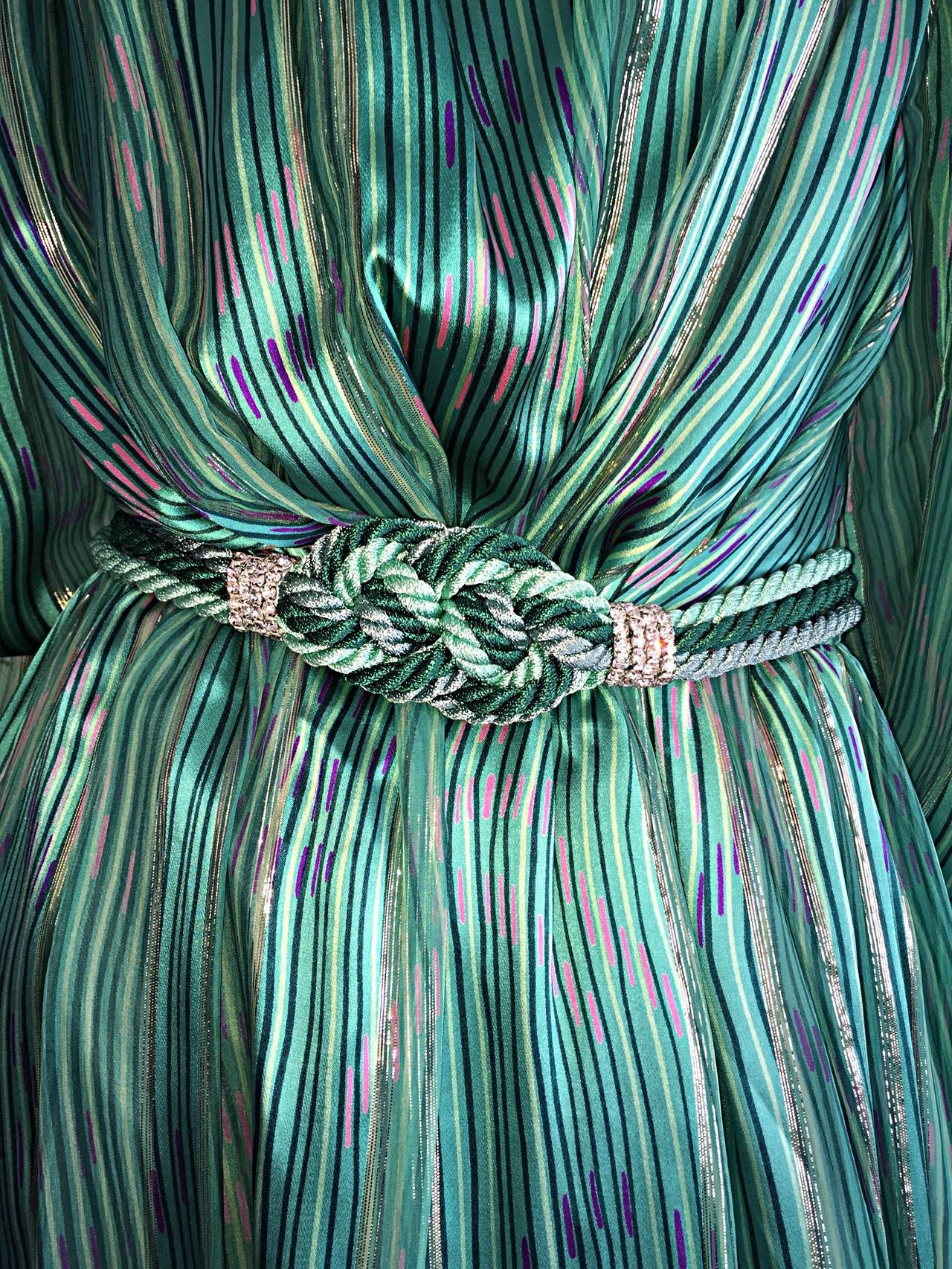 Drop dead gorgeous vintage silk dress, and silk braided belt! Vibrant green color, with multi-color patterns throughout. Rhinestones at collar, and on rope belt. Long sleeves, with green jewel closure at cuff. Detachable braided belt, that can