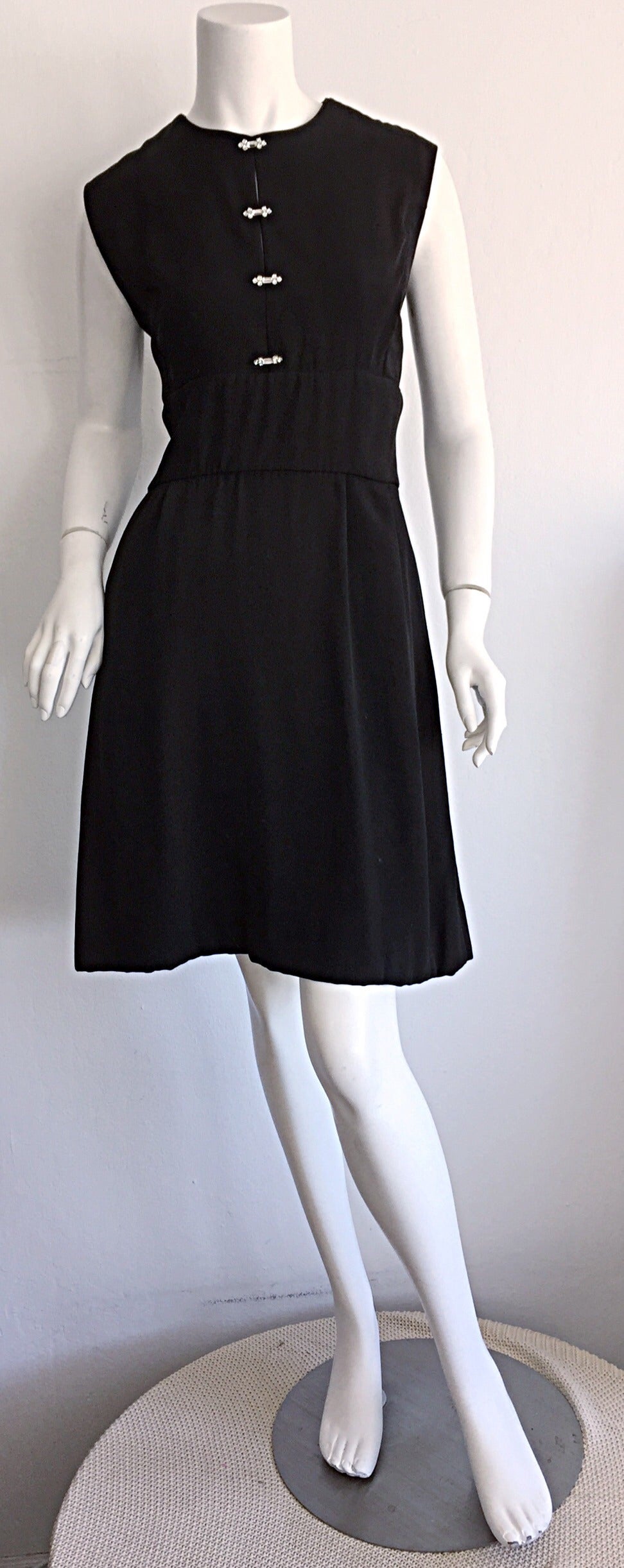 Beautiful 1960s Ceil Chapman dress, with rectangular rhinestones! Key-holes in between each set of rhinestones. Full A-Line skirt, with the intricate seams Chapman was famous for! An extremely flattering dress! This is the PERFECT little black