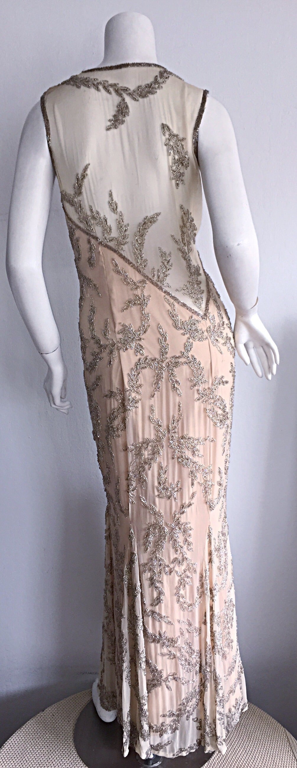 Simply stunning vintage nude illusion heavily beaded silk custom made dress! Layers of nude silk chiffon, with intricate beading detail throughout. Asymmetrical back, that is just so amazing on! Slight mermaid hem. There is so much expert tailoring