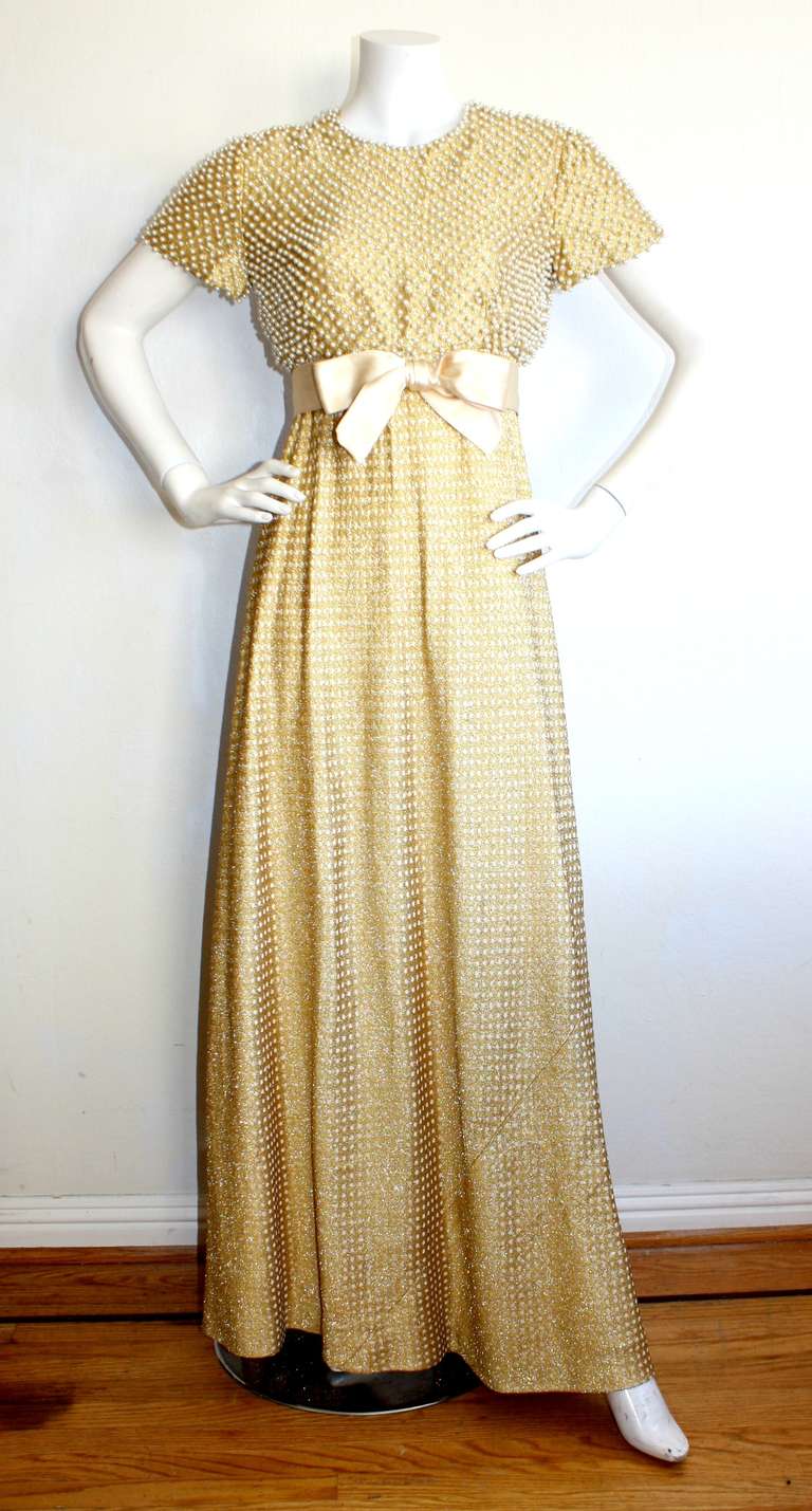 Geoffrey Beene vintage gold metallic gown. Hundreds of pearls adorned on top, with gold and white polka dots on skirt. Silk bow belt that buttons in back.