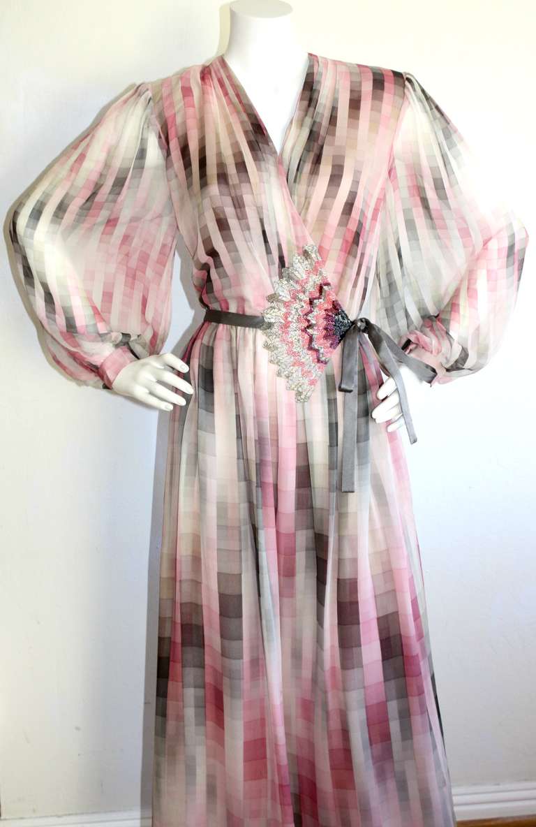 Gorgeous vintage Hanna Morie geometric print wrap dress with layers and layers of chiffon. Long billow sleeves that snap at cuffs. Gray silk ribbon wrap tie. Intricate beading detail at waist. Small-Medium