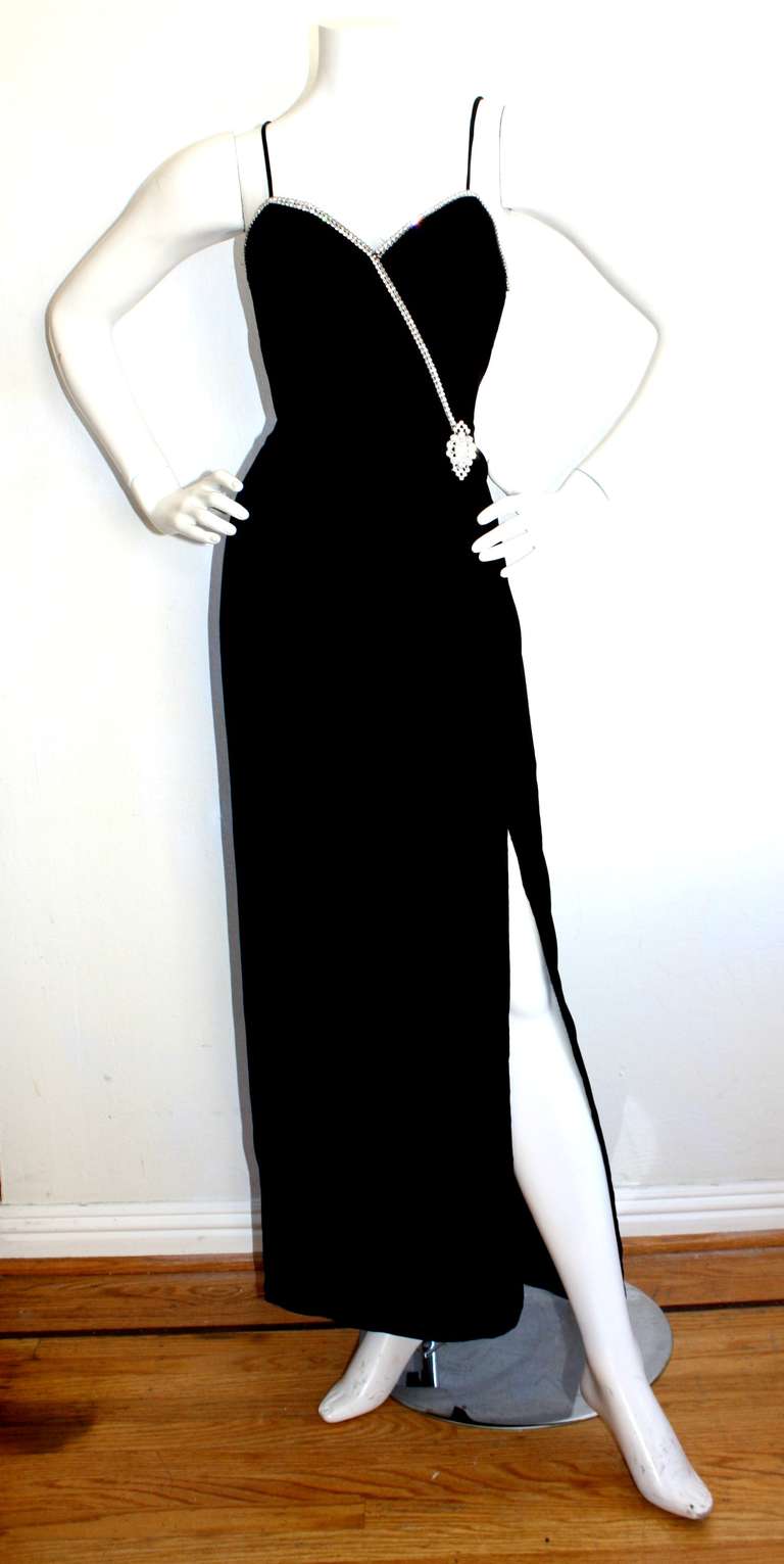 Yves Saint Laurent black velvet vintage gown, with rhinestone detail at bust and sparkling diamanté accent waist. Sexy slit up front. Simply stunning! In great condition. Marked size 40