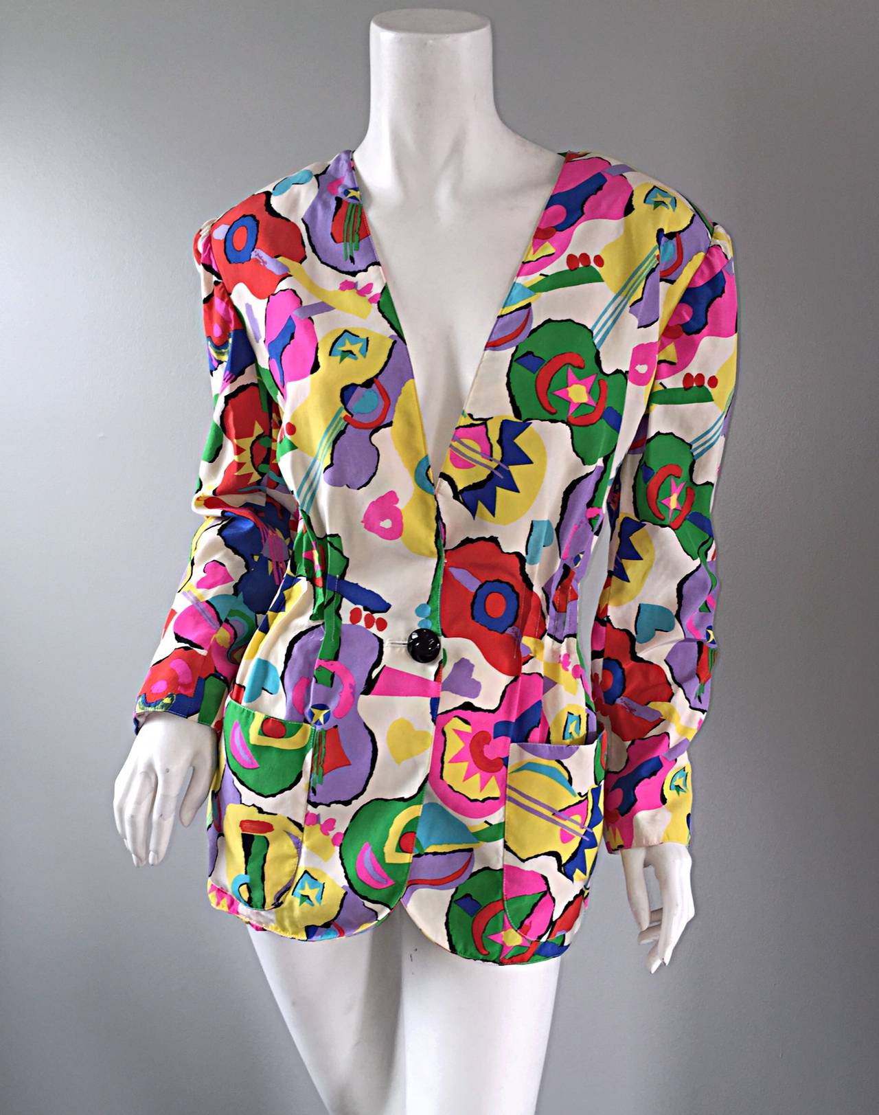 Incredible vintage Emanuel Ungaro silk blazer/jacket! Novelty guitar and heart prints throughout! Vibrant colors, with an incredible fit.. Pleating details below bust make for a very flattering fit. Single black lacquered button at waist, with a