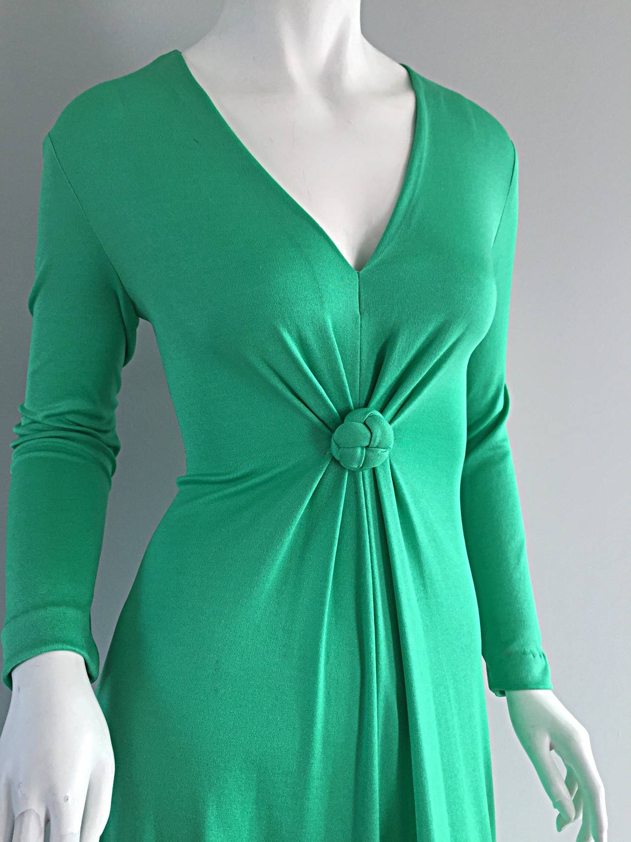 Very rare early 1970s Frederick's of Hollywood kelly green maxi dress! Slimming fit, with sleek long sleeves, and superb v-neck bust. Knotted detail at waist. Such a stunning dress, that can easily be taken from day to night. Zips up the back. Looks