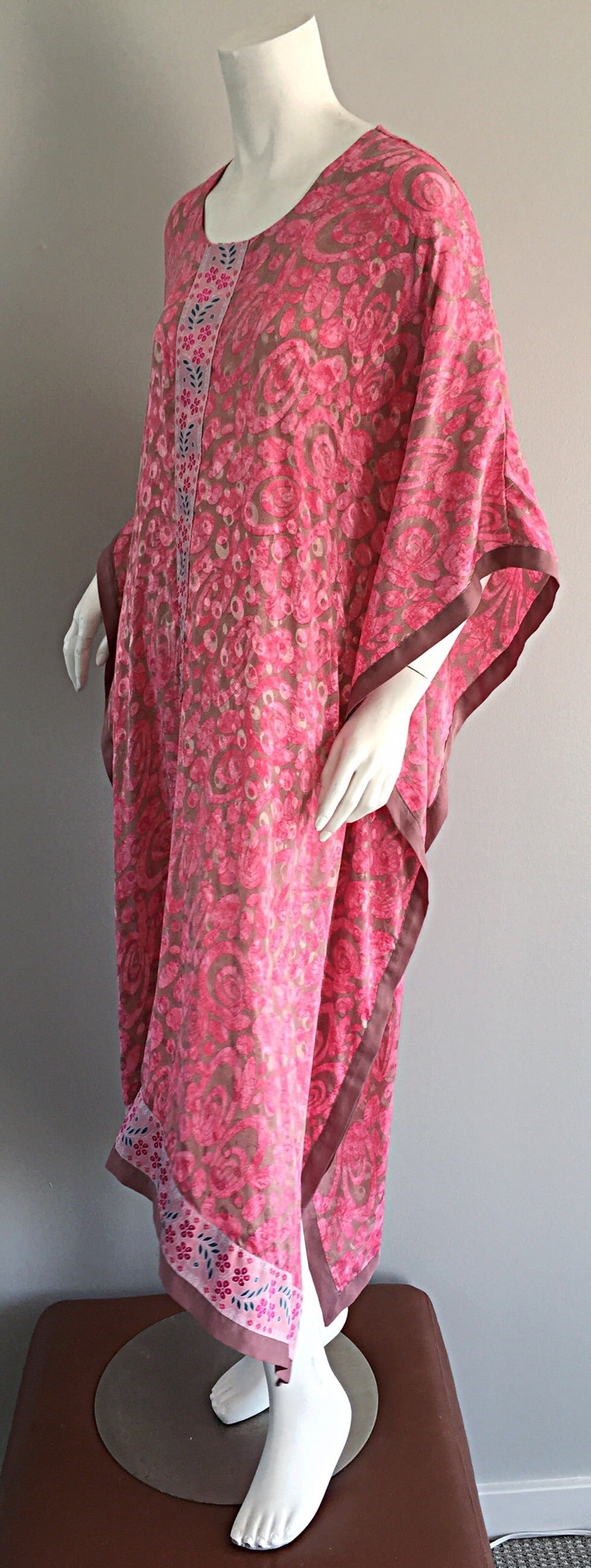Beautiful vintage kaftan/caftan! Vibrant colors of pink and taupe, with floral embroidery down front center, and at hem. Perfect alone, or belted. Can easily be worn over a swimsuit. Asymmetrical hem. Super lightweight silk. Great with sandals or