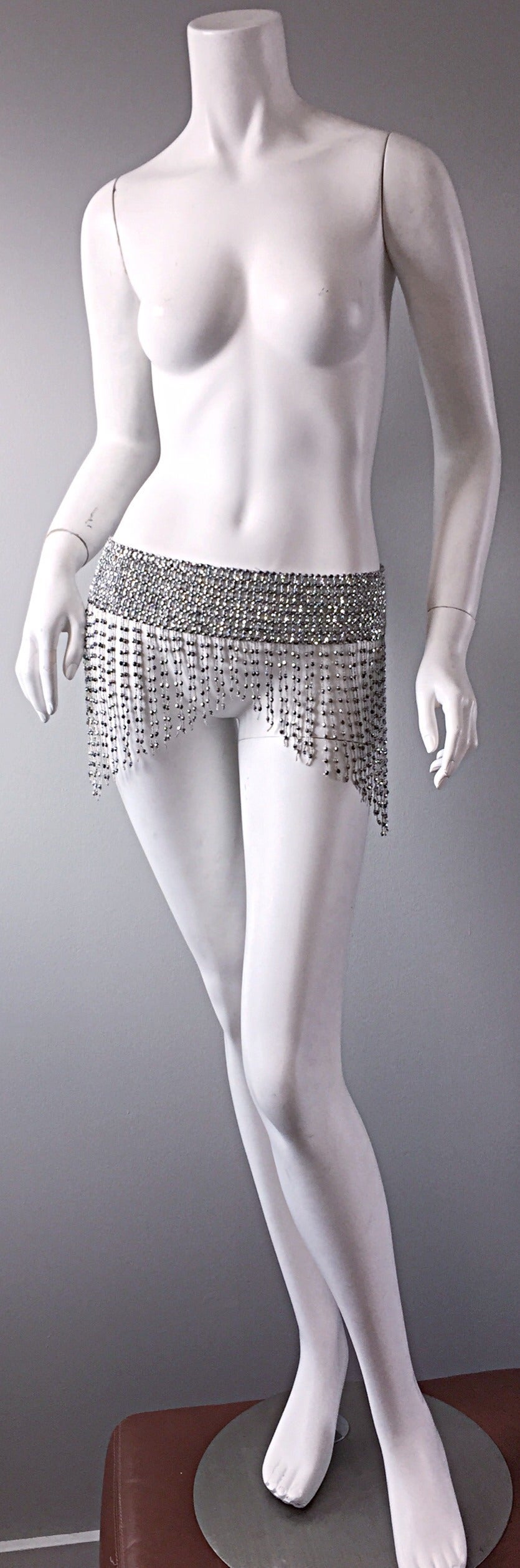 Awesome 1970s disco belt! Shiny rhinestones and beads that literally swing with motion! Intricate details. Looks great with jeans, leggings, a skirt, or simply over a dress. Two loops in the back for closure. Lots of stretch. 28-38 inch waist