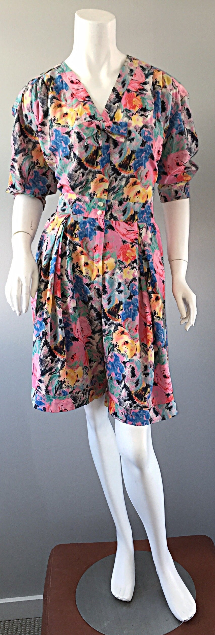 Chic vintage Emanuel Ungaro shorts ensemble! Beautiful floral watercolor print throughout. High-waisted shorts, with zipper, and double buttons at waist. Pockets at both sides of waist. Blouse features bow at bust, and slight 'puff' sleeves. Great