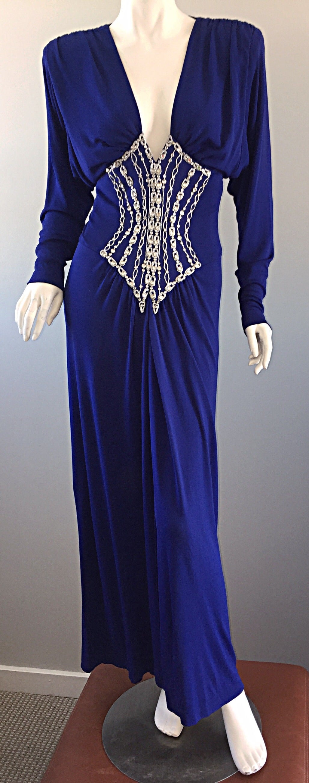 Incredibly sexy vintage Bob Mackie royal blue silk jersey dress! Striking vibrant color, that features 'extreme' shoulders that resemble a 1940s style. Rhinestone encrusted bodice that slims the waistline, along with interior boning. Peek-a-boo