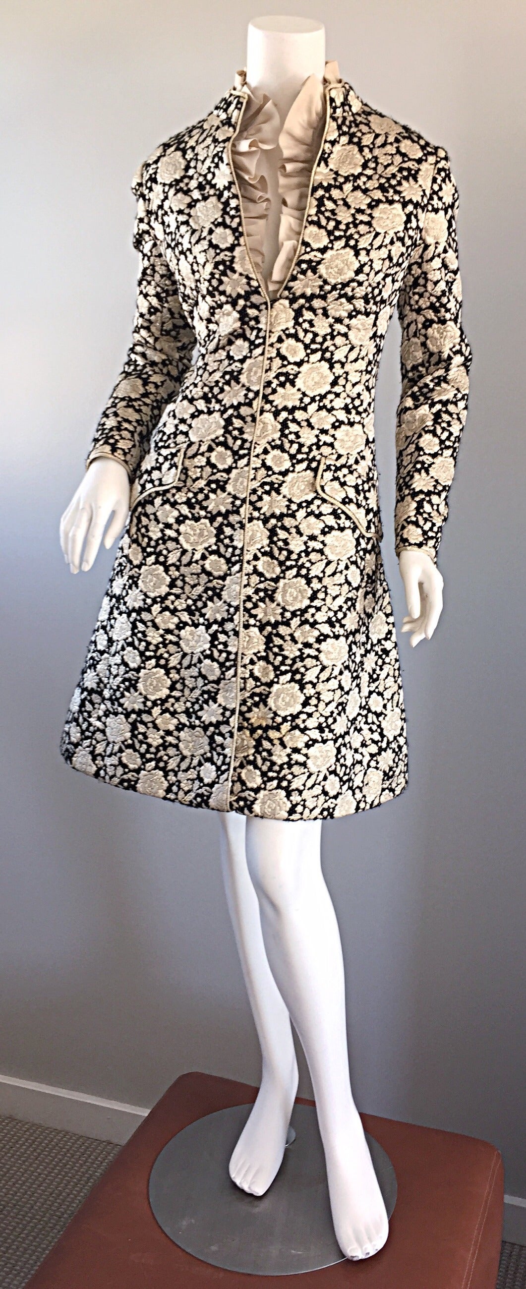 Beautiful 1960s Mollie Parnis dress! Wonderful black and gold silk brocade fabric, with silk ruffle detail at neck. Perfect A-Line shape that flatters every figure! Hidden zipper up the front. All interior labels (besides Saks 5th Ave.) have been