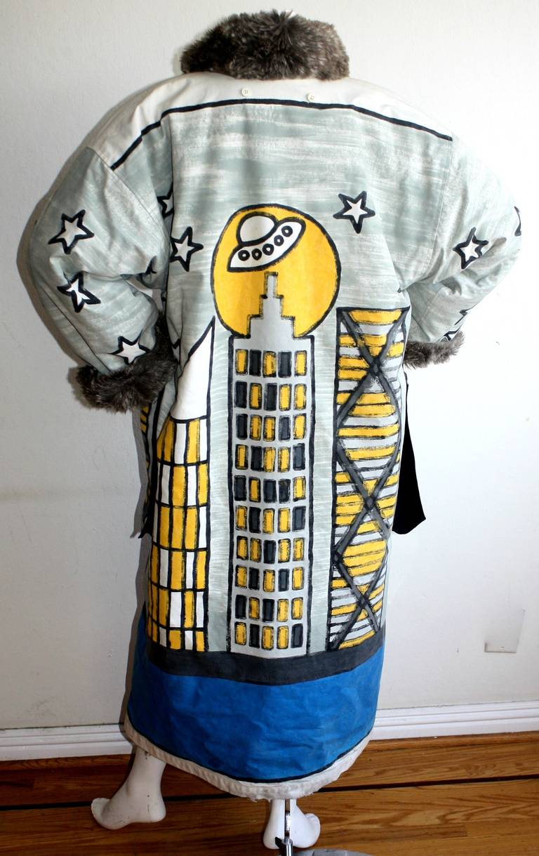 Remarkable, extremely rare vintage Jean Charles de Castelbajac reversible hand painted jacket. This is museum worthy! Painted skyline and stars on front, with space ship, and orbit on back. Reverses to a gray faux fur jacket. Cuffs and collar fold