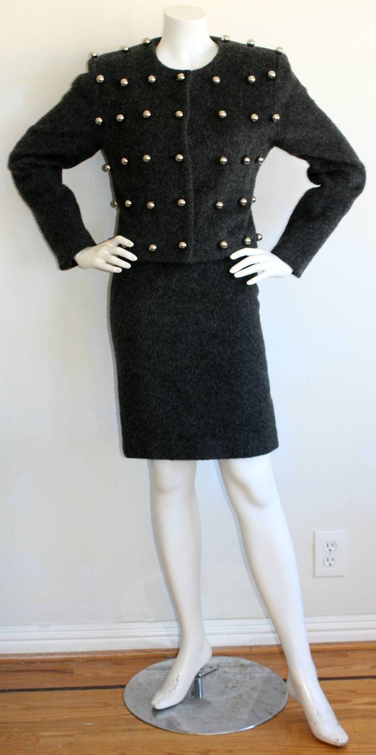 Classic Patrick Kelly charcoal gray ball suit. Features silver balls throughout front of jacket. Classic, sexy high waisted pencil skirt. Both pieces are great as separates. In great condition. Approximately Size Small -