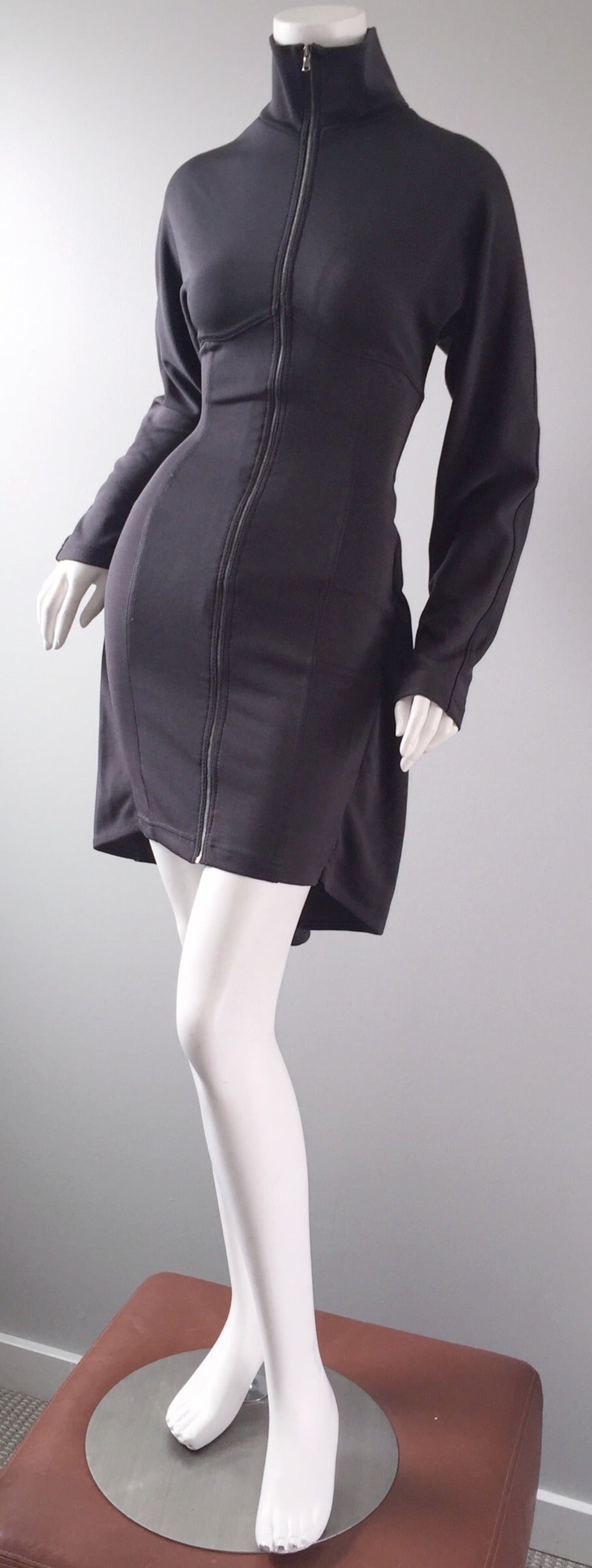 Amazing vintage Calugi E. Giannelli 'Avant Garde' grey BodyCon dress! Sleek long sleeves, with a fitted skirt, and an optical illusion cape detail. Drawstring detail on the back, that can control how tight you want this beauty. Zips up the front,