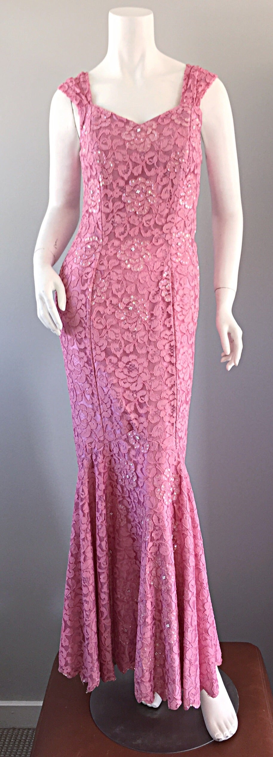 What a dress!!! This gorgeous 1950s mermaid dress could have easily been on any of the 50s starlets! Pink Chantilly lace, intermixed with sequins throughout. Fitted throughout the bodice, with a 'Mermaid' hem. Expertly tailored, with heavy attention