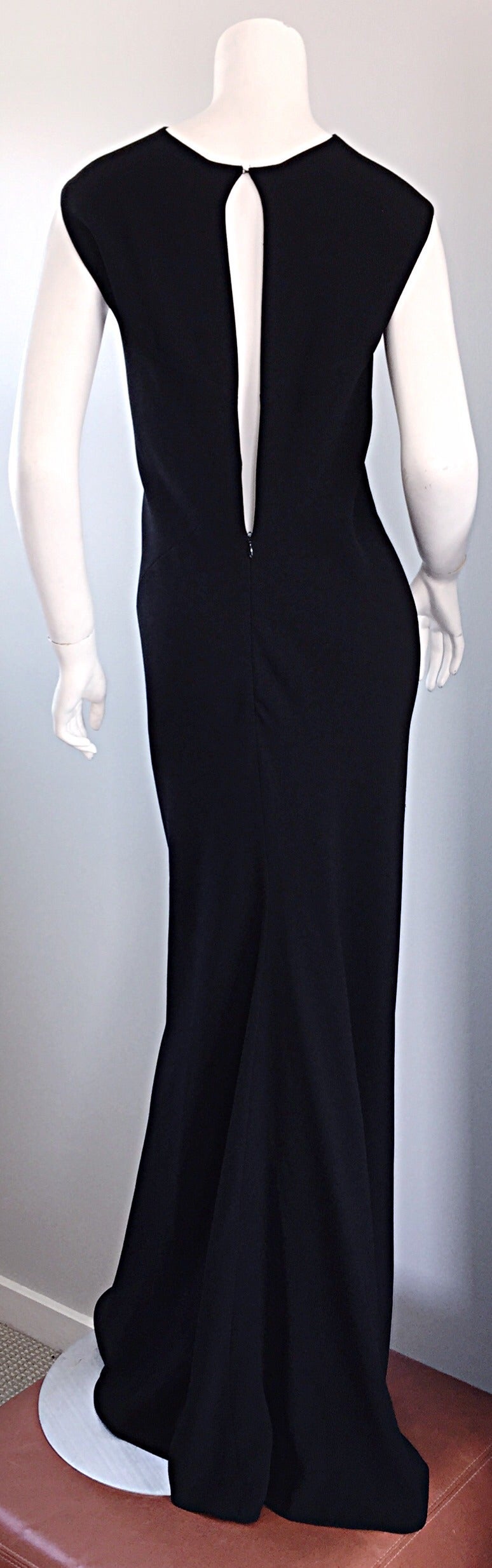 Stunning 1990s vintage Jean Paul Gaultier black gown! The lines, and cut on this beauty are just simply breathtaking! Who knew that a black gown could be made so beautifully? GAULTIER! Flattering sleeve cut, with a seductive, yet elegant open back.