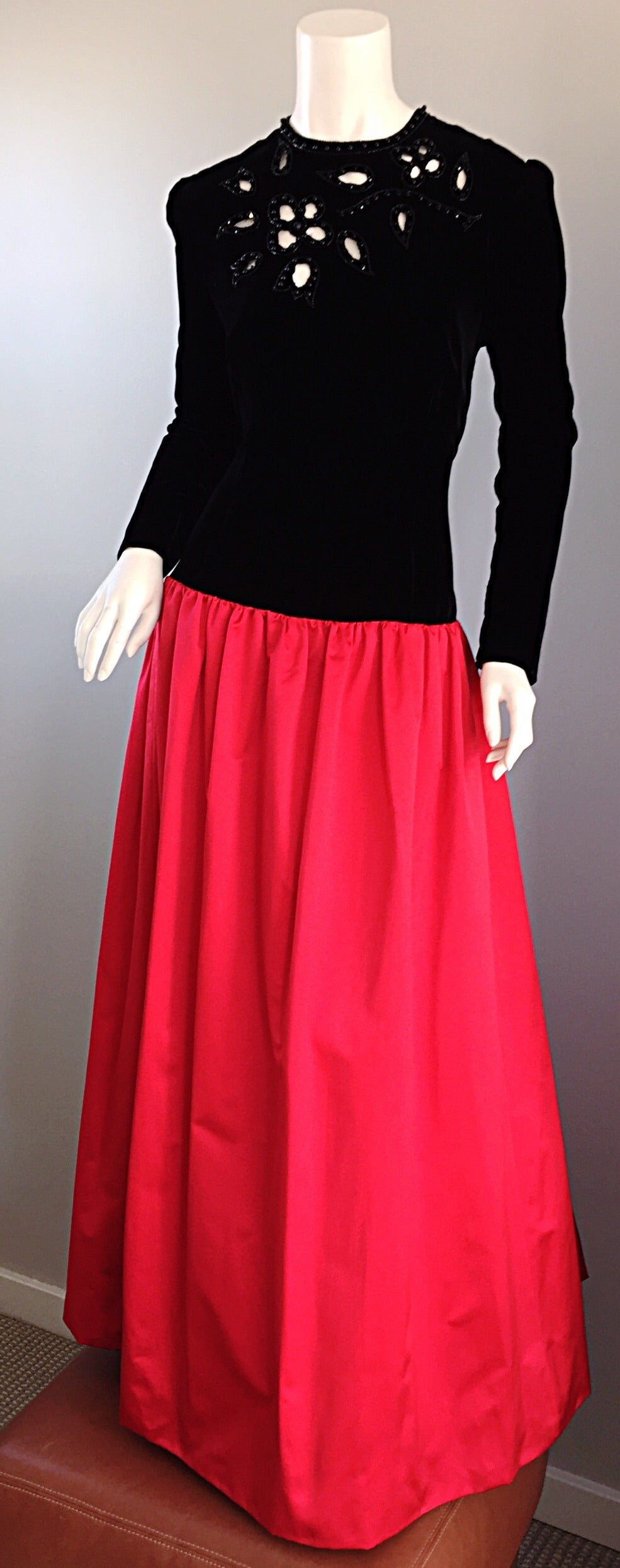 Absolutely stunning vintage Givenchy gown! Black silk velvet bodice, with cut-out detail, encrusted with black beads. Long silk taffeta full skirt in vibrant red. Sleek long sleeves. Slight drop waist is extremely flattering! Perfect gown,