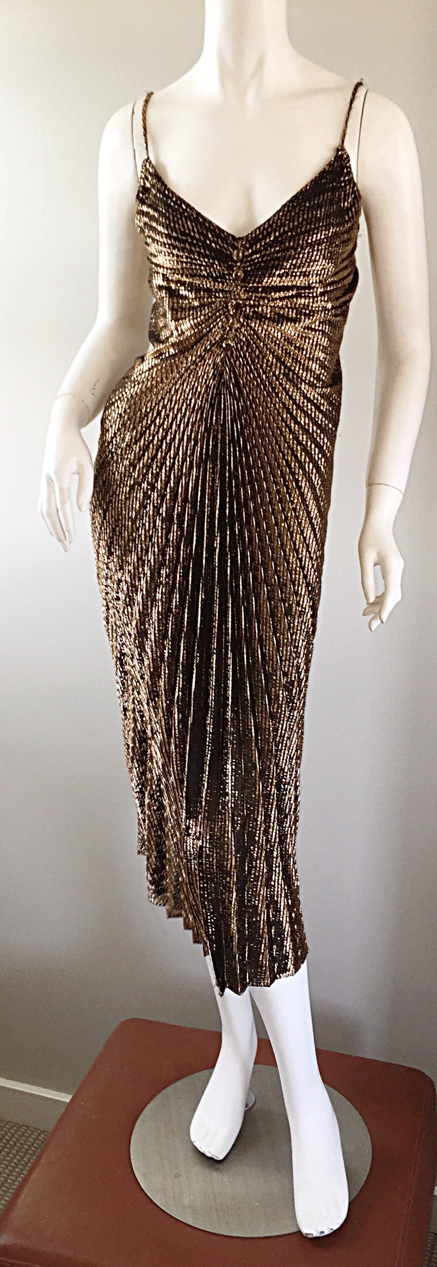 Sexy 70s disco dress!!! Striking bronze color, with accordion pleats throughout, which make for a very flattering feminine fit. Mock buttons (covered in same fabric) at bust. Perfect for your next Cocktail Party, or night out. Perfect from day to