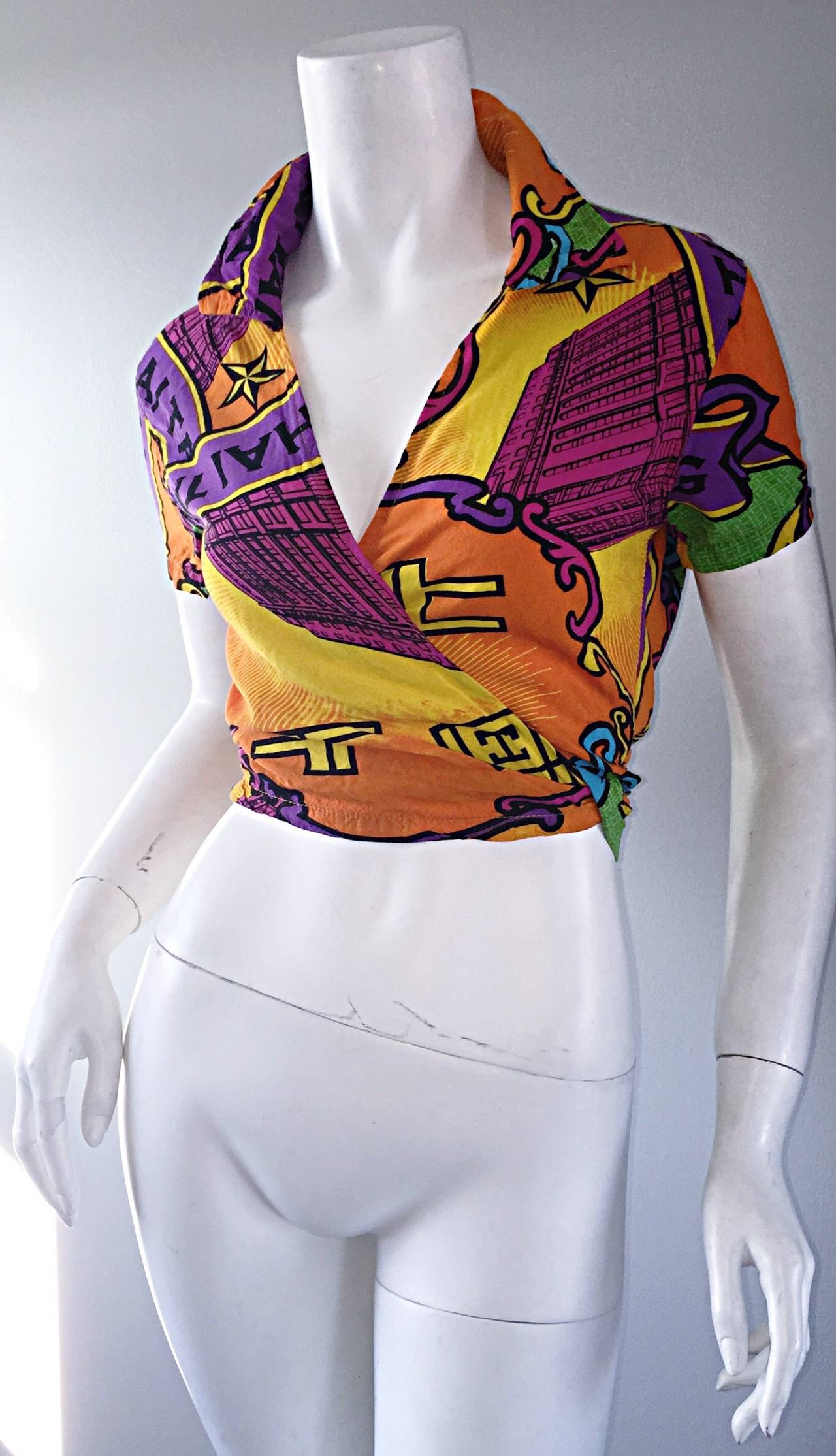 Awesome 1990s Shanghai Tang cropped wrap blouse! From the first collection put out by Shanghai Tang in 1994. Vibrant colors, with graphic designs throughout. Wrap style that ties in the back. Great with jeans, shorts, skirts, or trousers. 100%