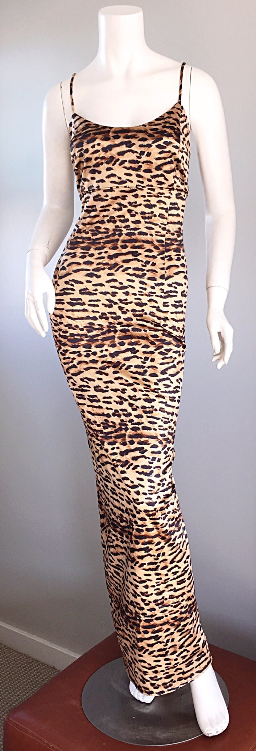 Iconic and super rare vintage Dolce & Gabbana leopard print bodycon dress! Super flattering fit, that hugs all the right places. Leopard spaghetti straps. Scoop back. Looks great alone, or belted. A true show stopper! In great condition. Made in