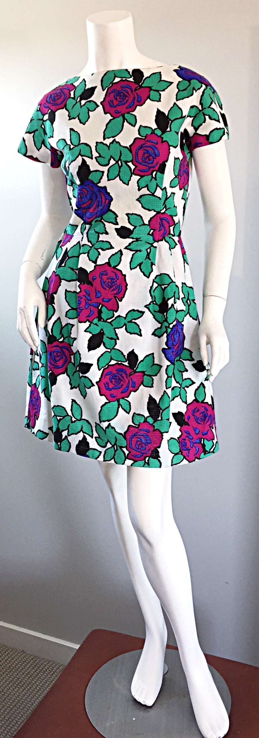 Adorable late 50s cotton dress! Vibrant 3-D flowers and leaves print throughout. Slightly flounced skirt. White honeycomb cotton, with a full metal zipper down the side. Looks great alone, or belted. In great condition. Approximately Size