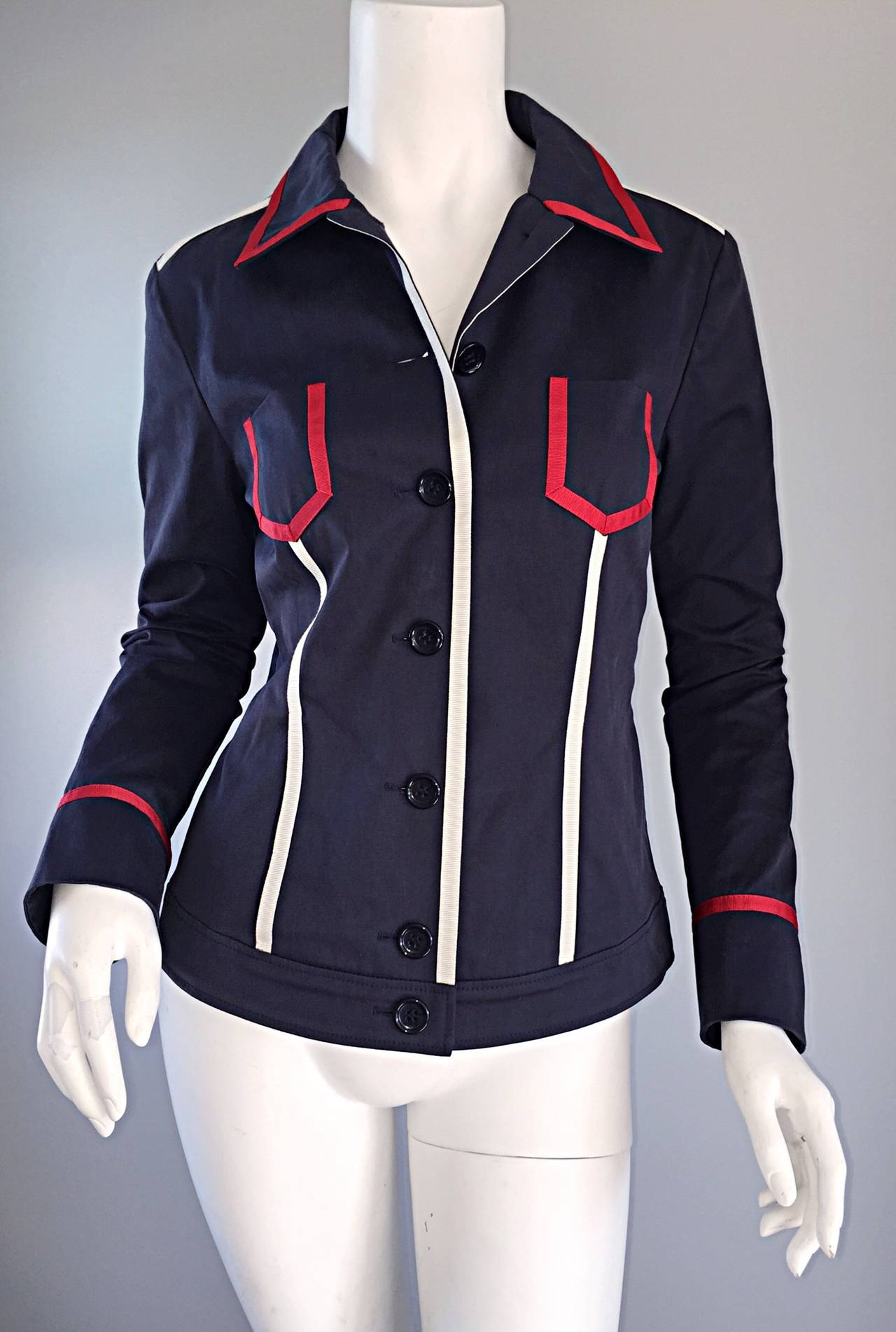 Nautical Escada navy blue jacket, with red and white ribbon detail throughout. The perfect lightweight jacket! Buttons all the way up the bodice, with buttons at each sleeve cuff. Great tailored fit that looks nice buttoned all the way up, or left