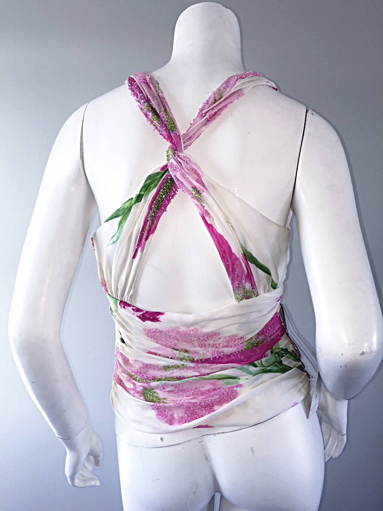 Gorgeous 1990s Carmen Marc Valvo silk chiffon beaded top (Brand new w/ original Saks 5th Avenue tags attached)! Beautiful watercolor floral print in pink, green and ivory. Wonderful and sexy twisted back. Hidden zipper up the side. Perfect with a