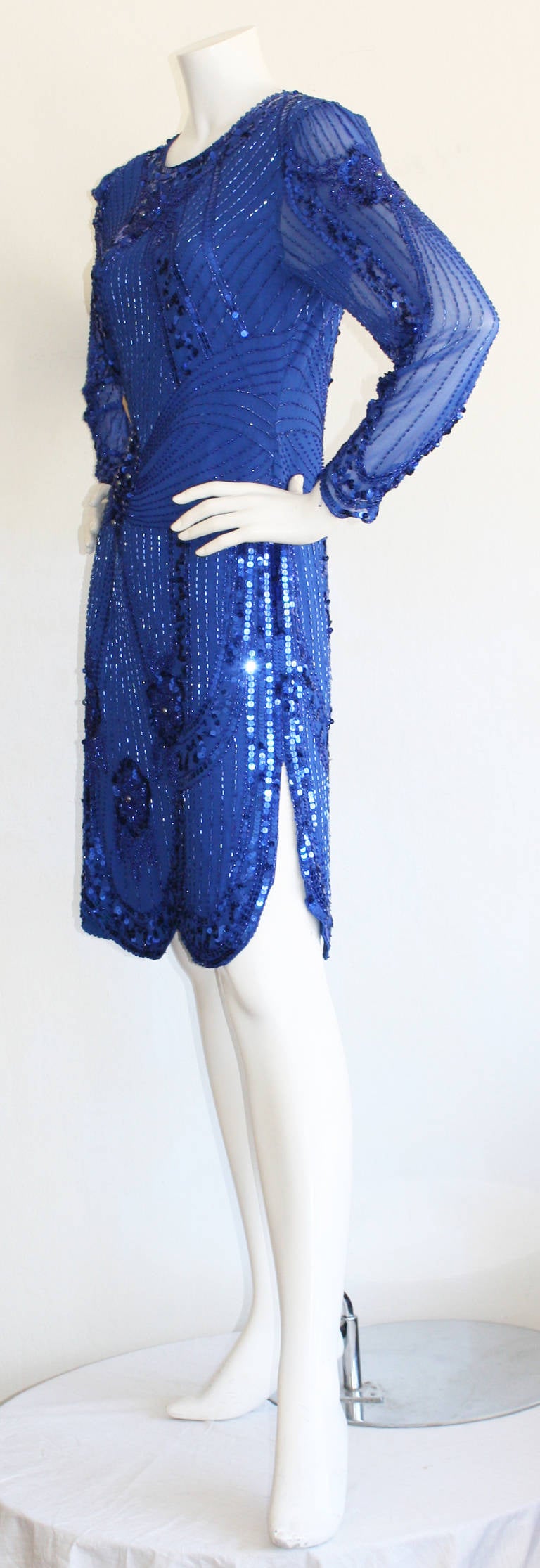Gorgeous vintage Lanvin blue sequin/beaded 'Flapper' style dress! Scalloped hem, that reveals just the right amount of skin. Long sleeves. Dress features intricate craftsmanship throughout. All silk, and lined. In great condition. Approximately Size