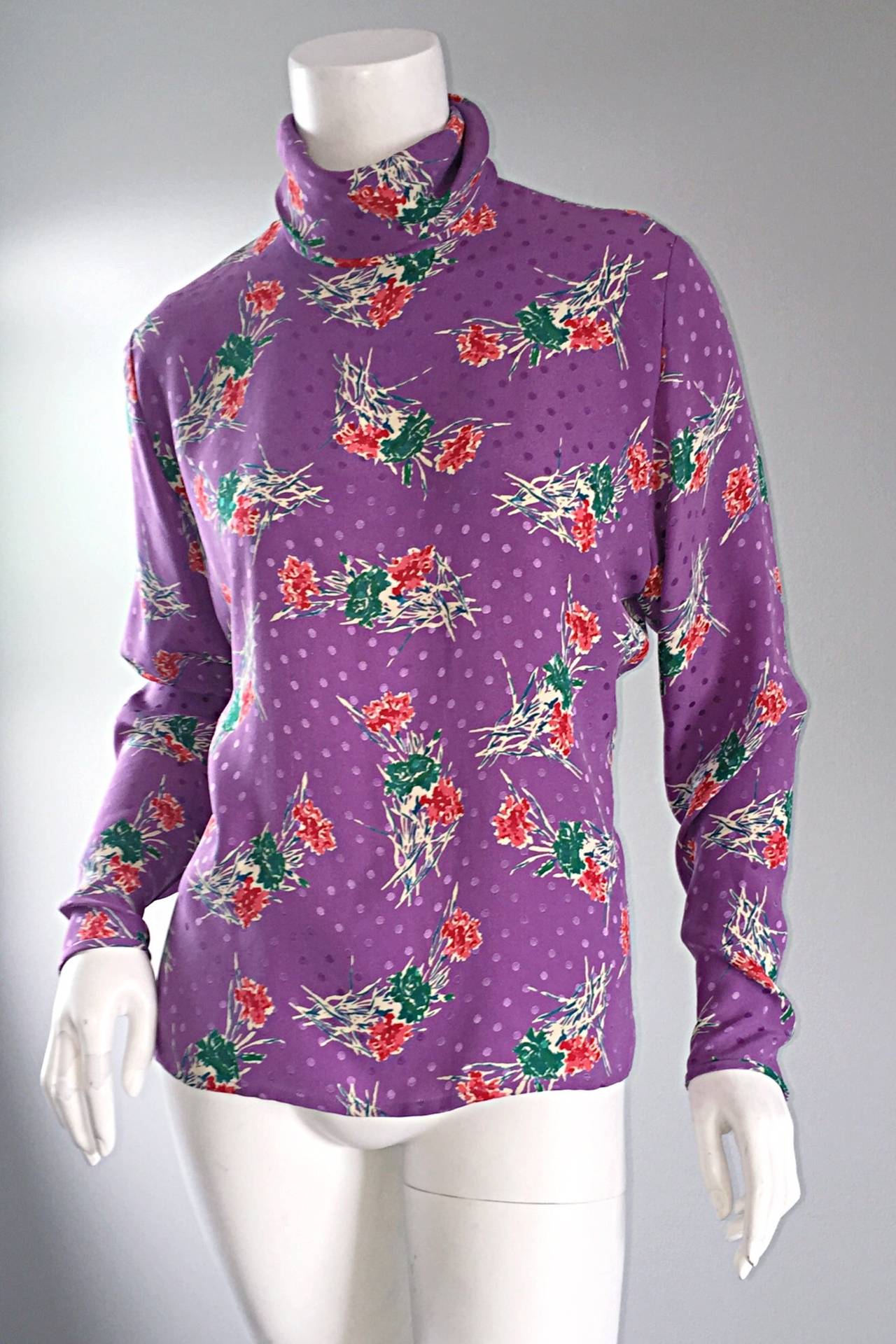 Such a chic vintage Emanuel Ungaro blouse! Light purple color, with bouquets of flowers (printed) throughout. Hidden zipper up the back, and at both sleeve cuffs. Chic buttons up top back neck. 100% Silk. Looks great belted, or alone. In great