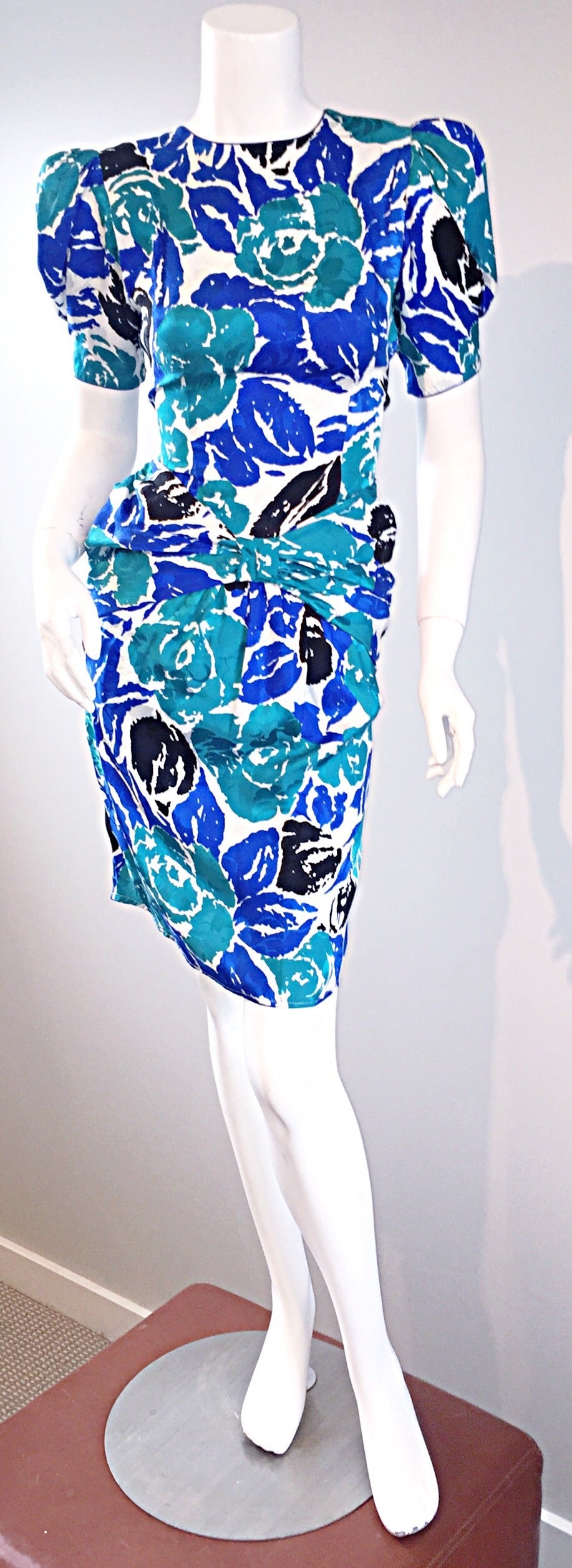 Beautiful vintage Flora Kung dress! Signature florals and vibrant colors Kung was so well known for. Ruching at waist makes for a very flattering fit. Shoulder pads can easily be snipped out, if desired. Hidden zipper up the back. In great