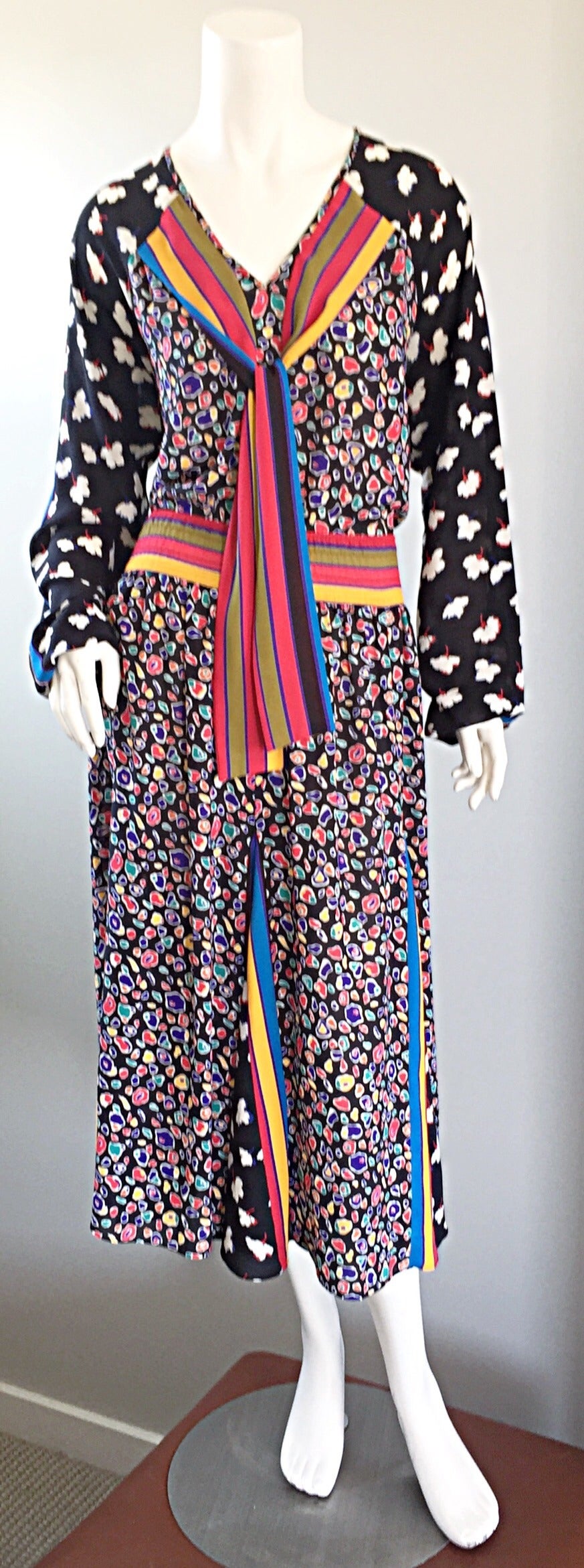 Amazing vintage 1980s dress, by Diane Fres / Freis! Op-art prints, with flowers on the sleeves, geometric shapes and stripes throughout body. Attached tie at neck. Looks amazing on! Can easily transition from day to night. Looks great with flats,