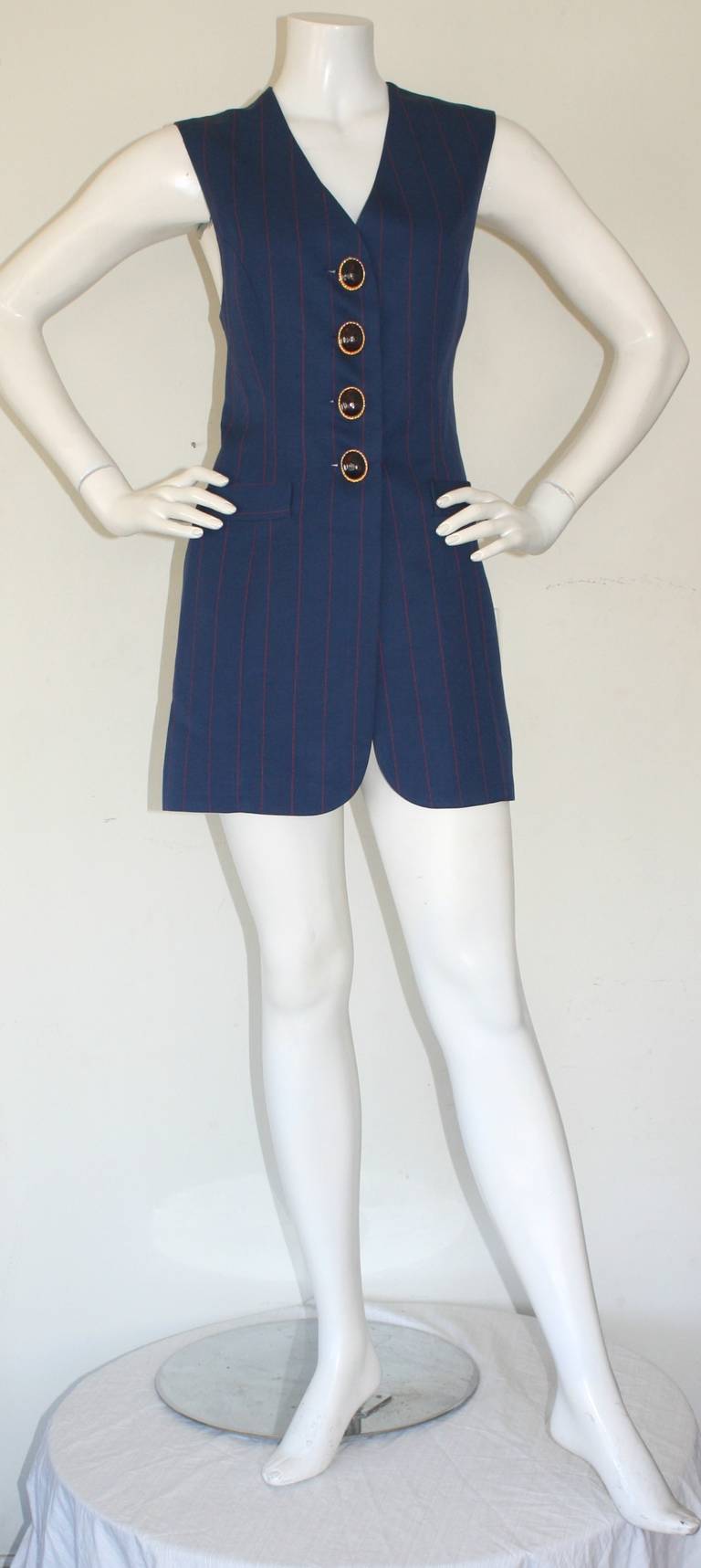 Chic vintage Christian Dior Haute Couture numbered waistcoat dress. Vibrant navy color, with red pinstripes. Amazing statement buttons in heavy red stones. In great condition. Will fit up to Size Medium

Measurements:
36 inch bust
30 inch