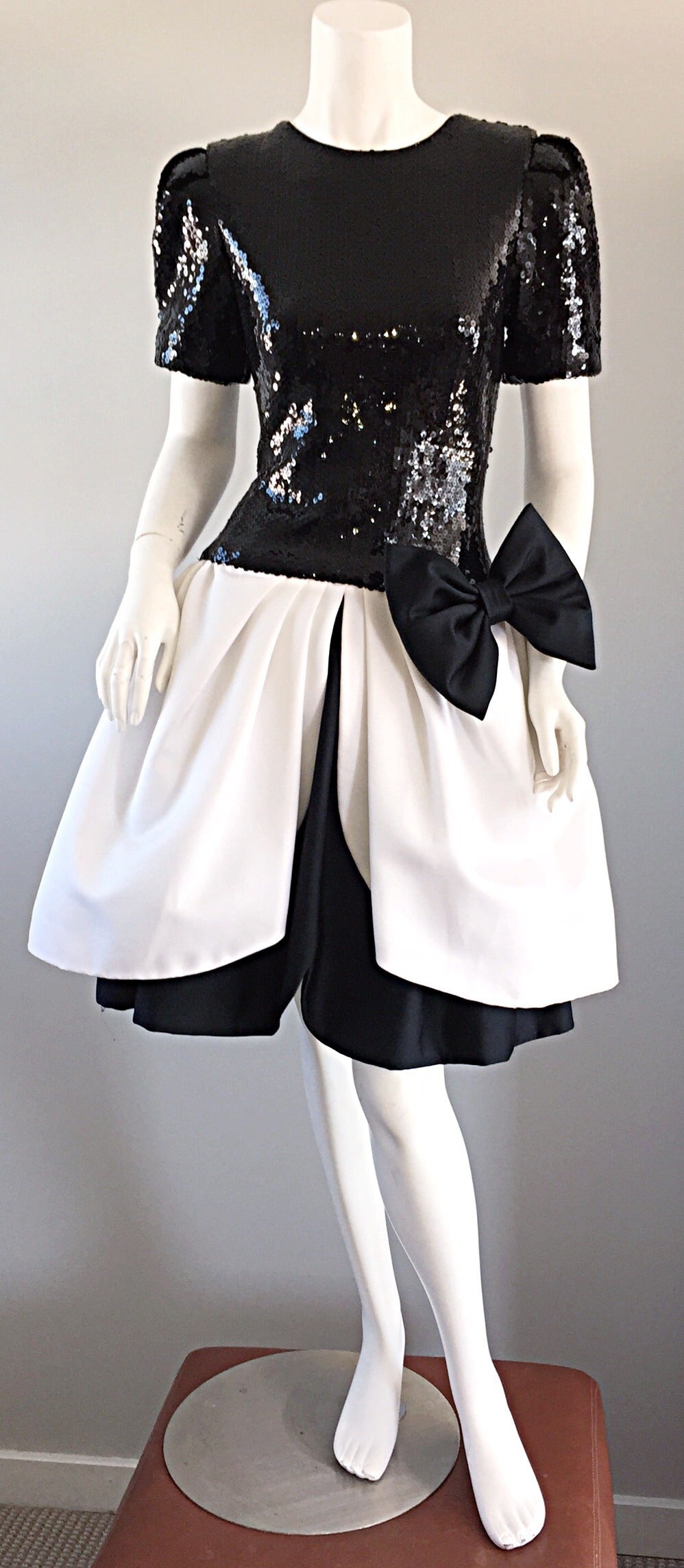 Incredible vintage black and white dress! Bodice is fully encrusted with sequins. Wonderful pouf skirt, with a chic silk bow on the side. Wonderful fit, that looks absolutely sensational on! Fully lined. Very well made. Hidden zipper up the back.