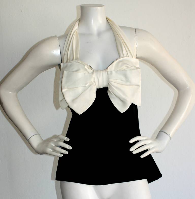 Sexy vintage Yves Saint Laurent (YSL) Rive Gauche halter top! White bow, and halter Babydoll style blouse. Black empire bodice, with side zip and hook-and-eye. Striking fitted bust with empire style waist. An exceptional vintage piece by a design
