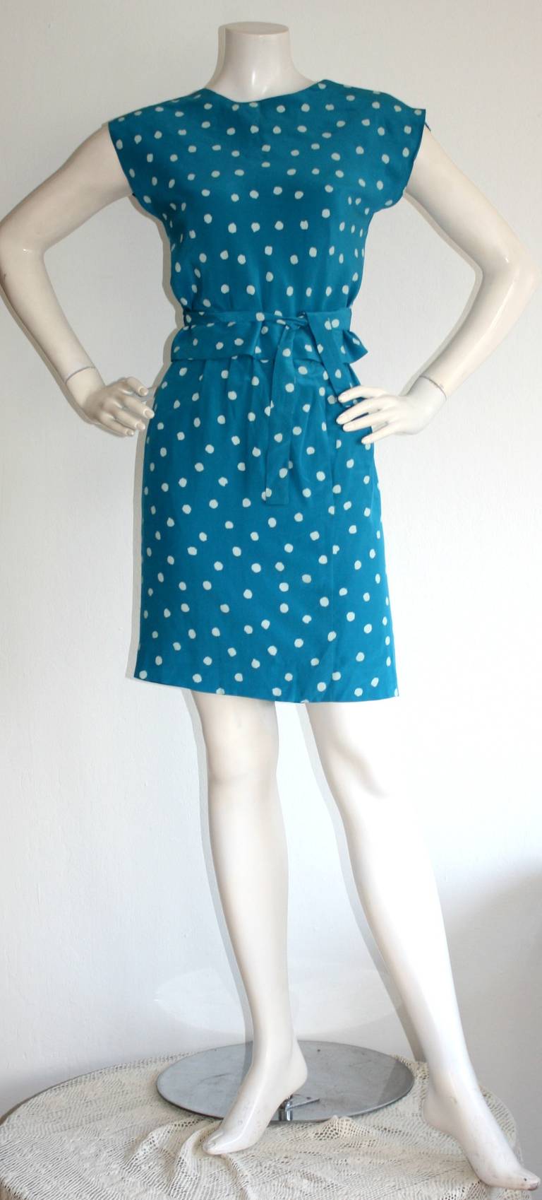 Cute vintage Oscar de la Renta blue silk polka dot skirt and wrap blouse ensemble. High waisted skirt, with a wrap tie blouse. Perfect alone, or as separates. Great for night or day. Pair with sandals, wedges or heels. One pocket on side of skirt.