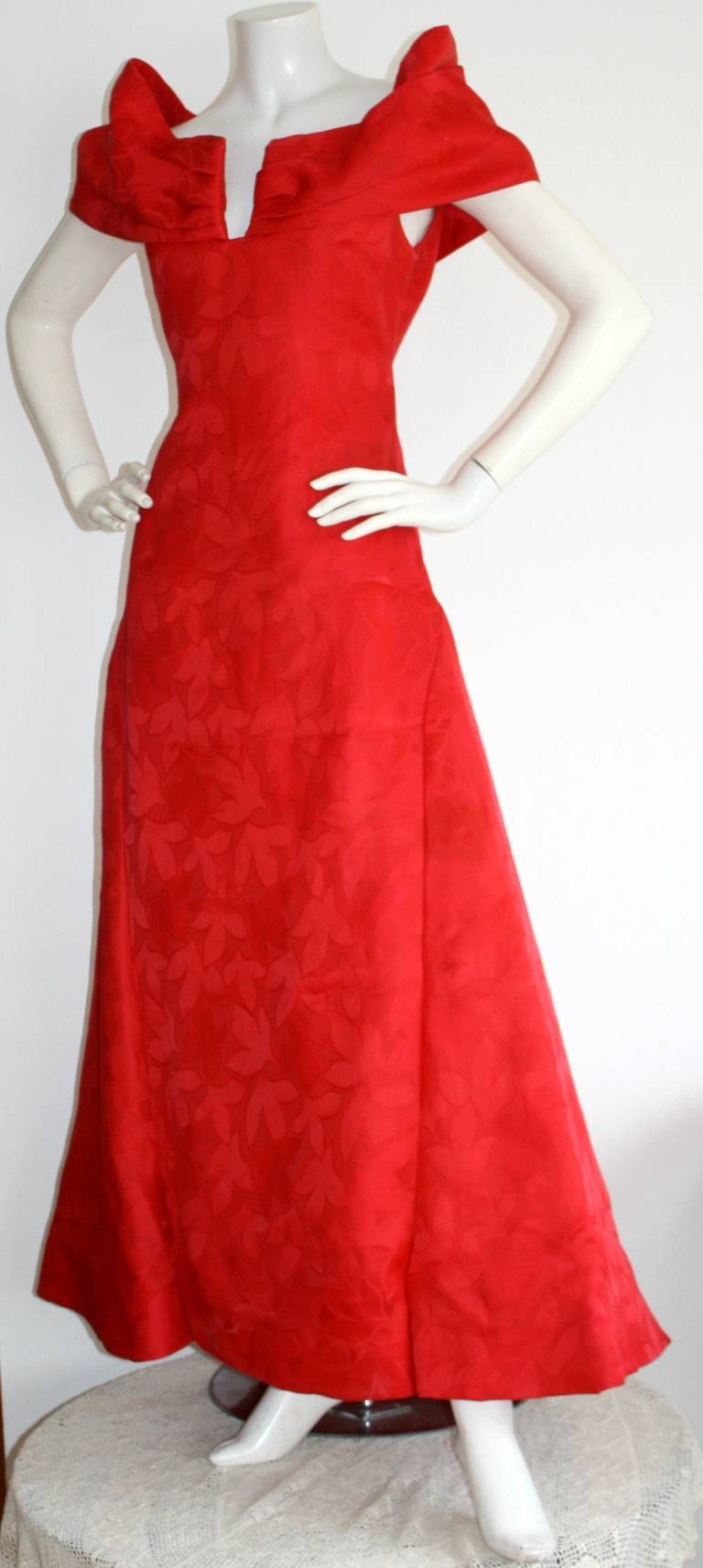 Sexy vintage Arnold Scaasi bright red ball gown! Perfect amount of cleavage, and shoulders! Faint floral print on this silk beauty. Full skirt with attached crinoline. In great condition, with minor wear to the lining, which does not show when worn.