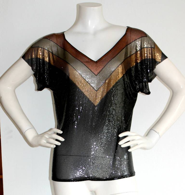 Stunning vintage Whiting & Davis metal mesh top blouse! Features Chevron print at neck, with stripes of silver, bronze, black and gold. In great condition. Marked Size Medium

Measurements: 
40 inch bust
36 inch waist