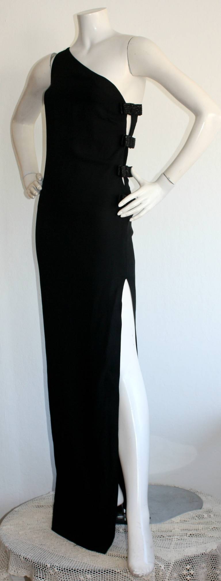 Featuring the sexiest vintage John Galliano for Christian Dior one-shoulder gown! Dramatic slit up the thigh, with crystal encrusted bows securing cut-outs at side of bodice. Fully lined. In great condition. Approximately Size