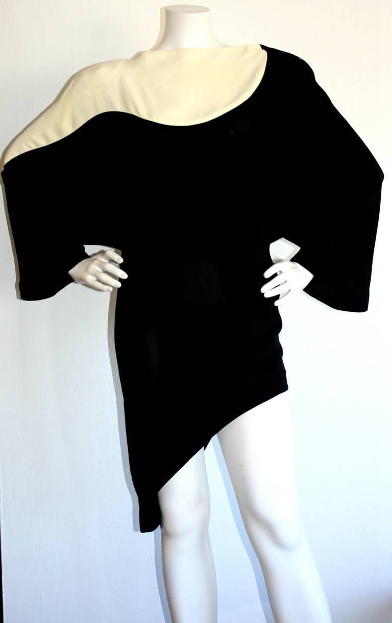 Featuring a rare vintage Thierry Mugler black & white 'Space Age' asymmetrical mini dress/tunic! Beautiful dolman sleeves, with signature snaps at collar. Snap pocket at waist. Incredibly chic, and easily transforms from day to night. In great
